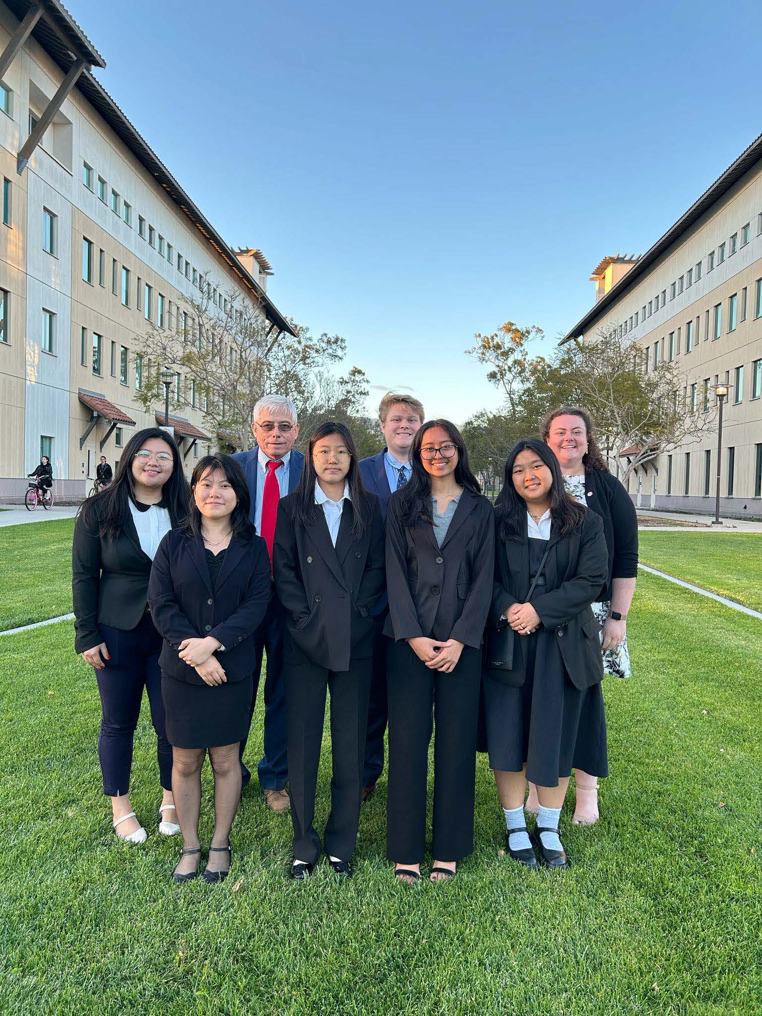 MHS Moot Court competitors Jenny Zhang, Yejin Son, Princes Habal, and Julia Taitano stand with coaches and chaperones Jia Jin Xu, Stephen Woodruff, Patrick Quimby, and Paige Lehman on the University of California Santa Barbara campus.