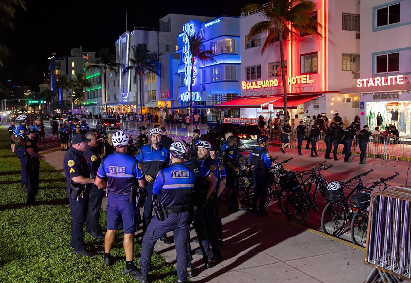 Police officers gather on Ocean Drive before the start of a midnight curfew during spring break on Friday, March 15, 2024, in Miami Beach, Florida. (Matias J. Ocner/Miami Herald/TNS)