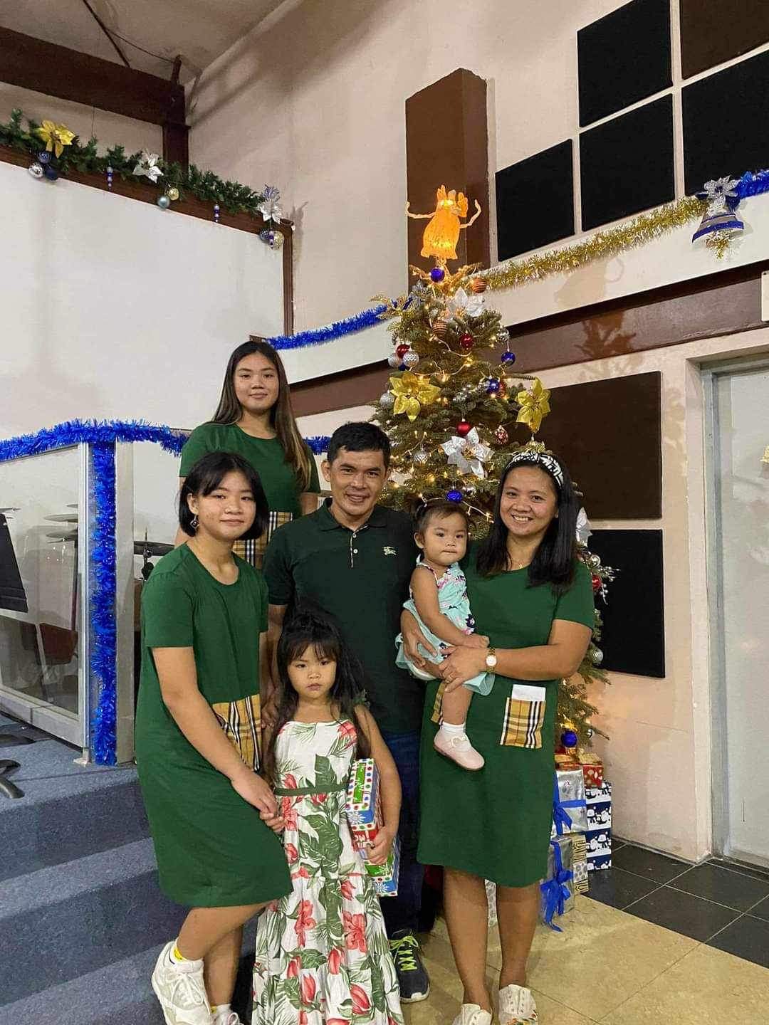 Juliana Rivera, back row, Kasandra Rivera, 2nd row, Jesse Rivera, Samarah Rivera, Sharolyn Alvarez and Gabbie Rivera, front, in a Christmas photo taken in 2021, five months before Jesse Rivera suffered a heart attack on Saipan while playing basketball. Sharolyn Alvarez is seeking the community's support as she navigates immigration and income concerns while trying to hold her family together with the help of her friend Arianna Pando.
