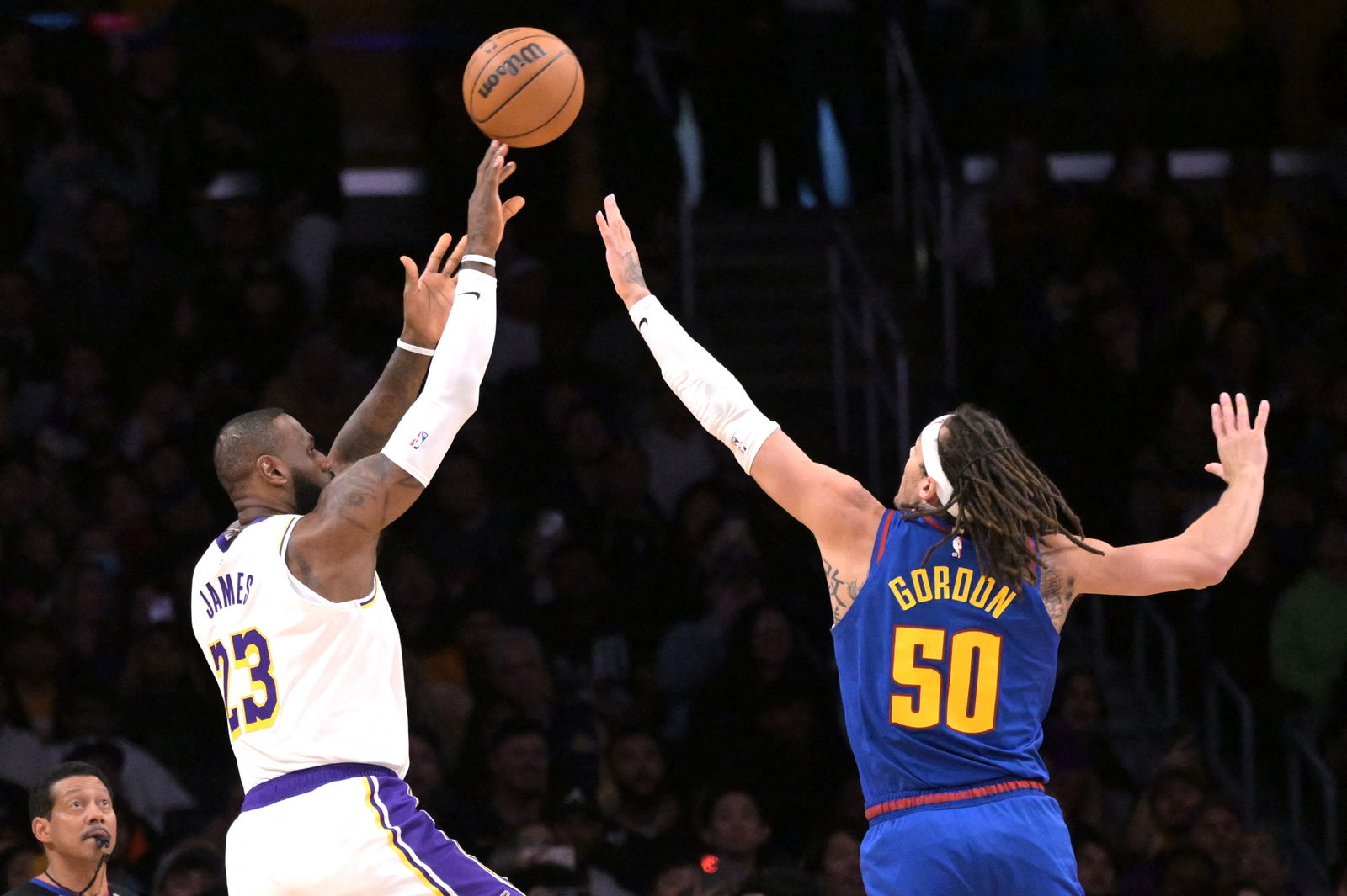 Mar 2, 2024; Los Angeles, California, USA; Los Angeles Lakers forward LeBron James (23) shoots a three-point basket over Denver Nuggets forward Aaron Gordon (50) in the first half at Crypto.com Arena. 