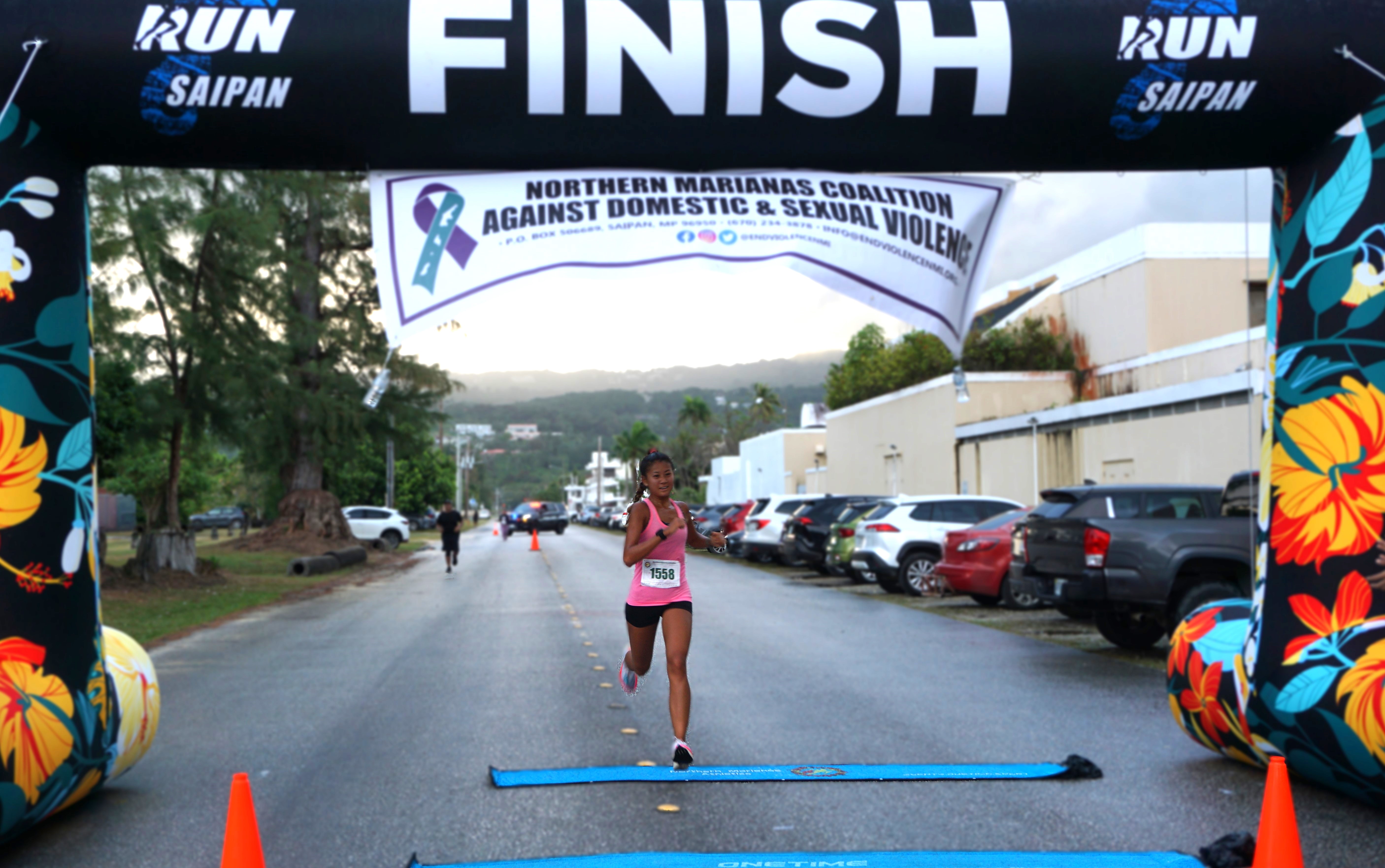 Tania Tan smiles as she crosses the finish line to finish first in the 10K distance of the 4th 10KM NMI Women's Run at Micro Beach on Saturday.