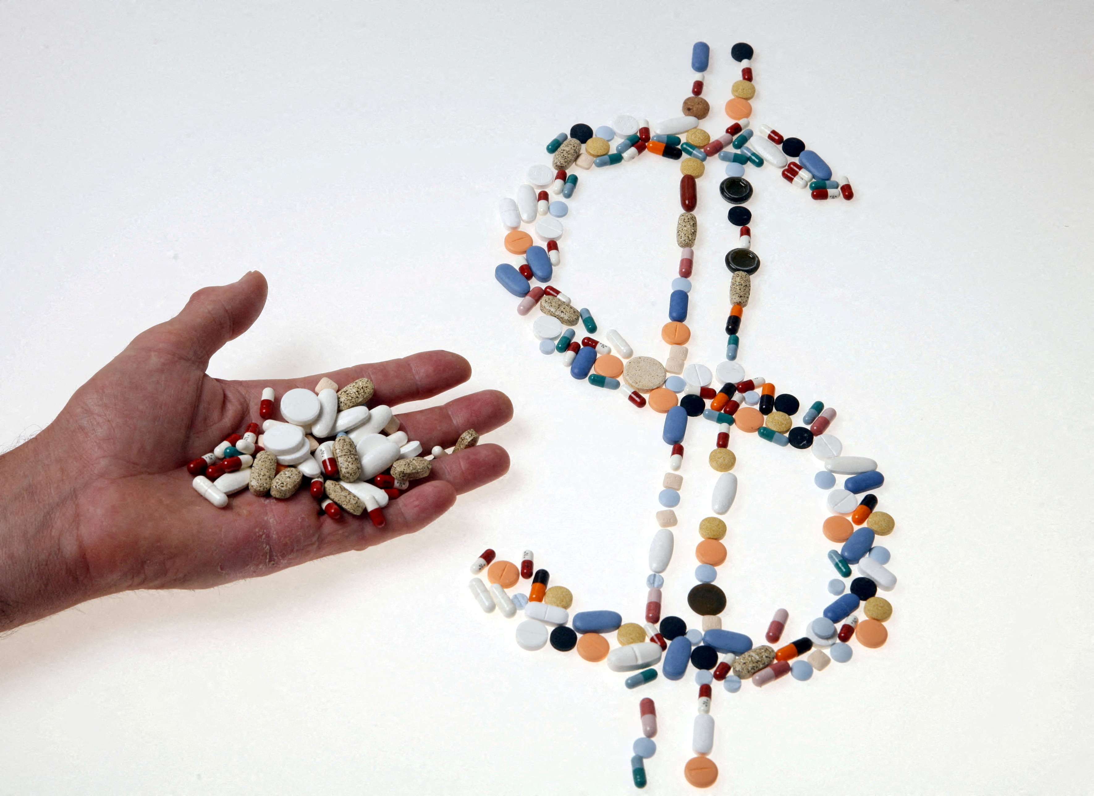 FILE PHOTO: Pharmaceutical tablets and capsules are arranged in the shape of a U.S. dollar sign on a table in this picture illustration taken in Ljubljana August 20, 2014. 