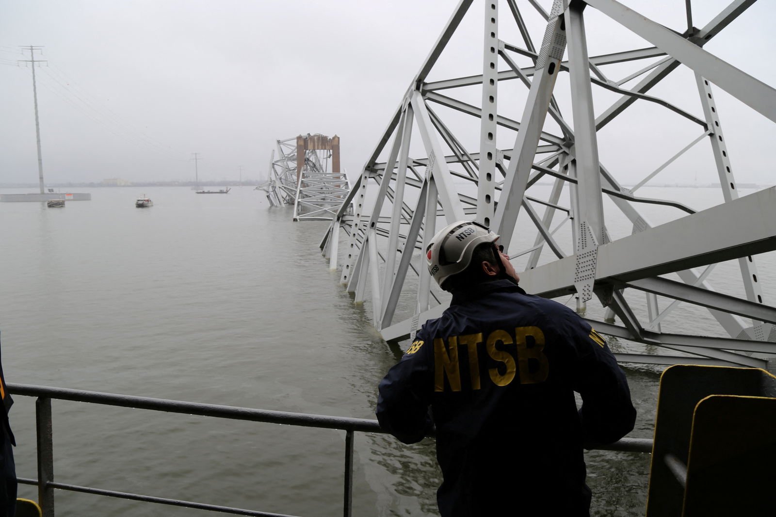 A National Transportation Safety Board (NTSB) worker looks on at the cargo vessel Dali, which struck and collapsed the Francis Scott Key Bridge, in Baltimore, Maryland, U.S. March 27, 2024. 