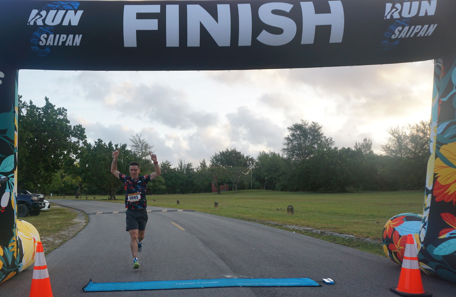 Jody O'Sullivan raises his hands as he crosses the finish line of Run Saipan’s 4th Annual Mangrove 5K at American Memorial Park on Saturday.