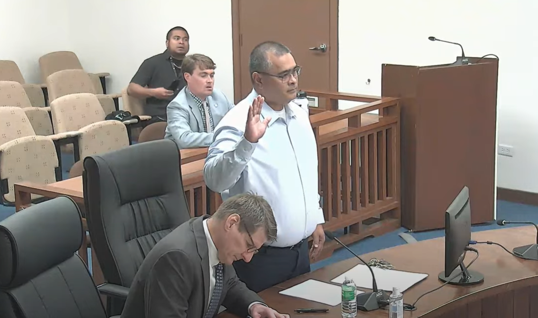 Former Finance Secretary David DLG Atalig is sworn in by the House special panel. With him is his lawyer, Bruce Berline, left.