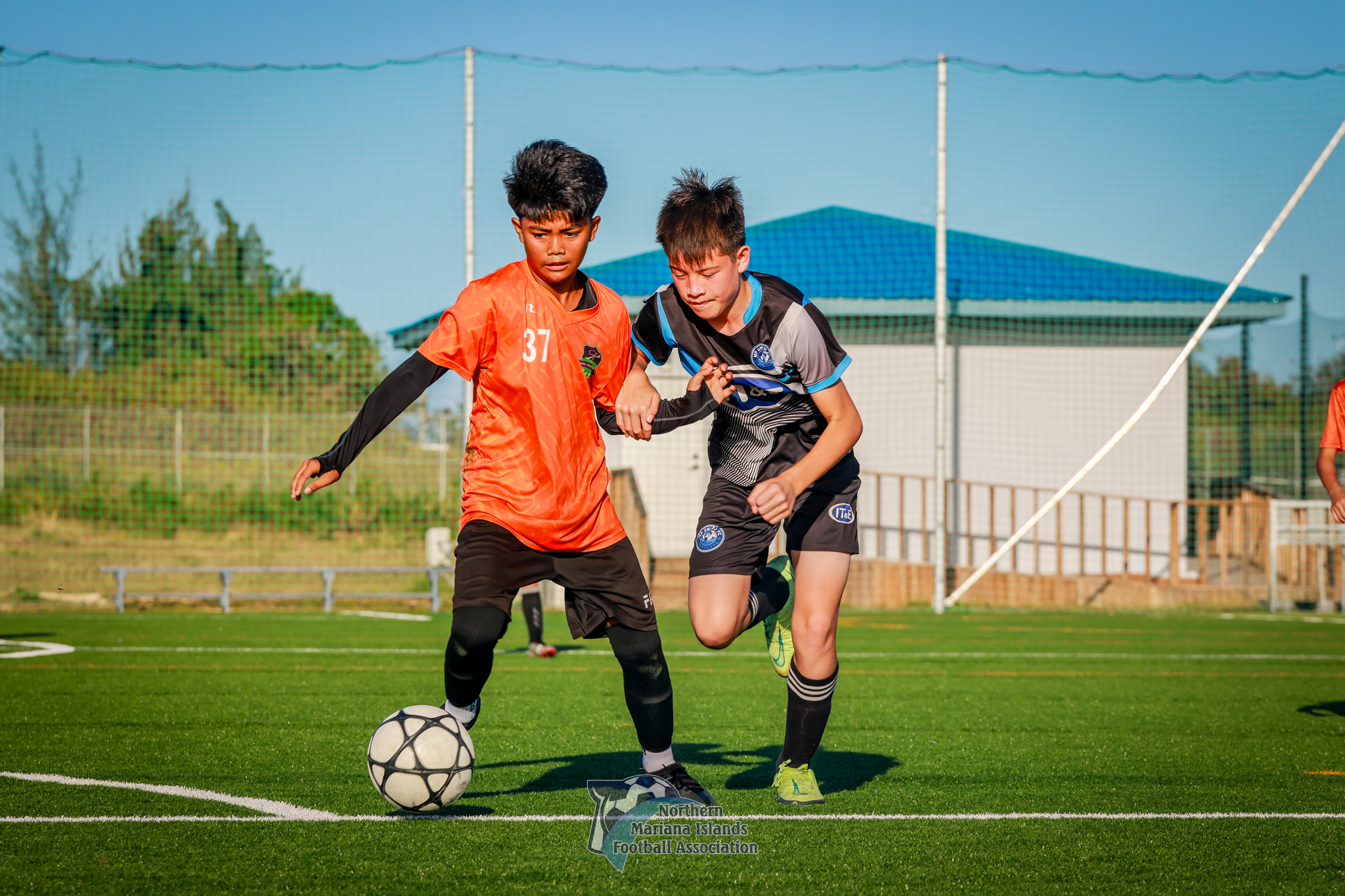 Kanoa 1’s Aldric Antonio and MP United’s Xavier Camacho battle for the possession during a U14 boys division game of the 2024 TakeCare Youth Soccer League at the NMI Soccer Training Center in Koblerville on Saturday.
