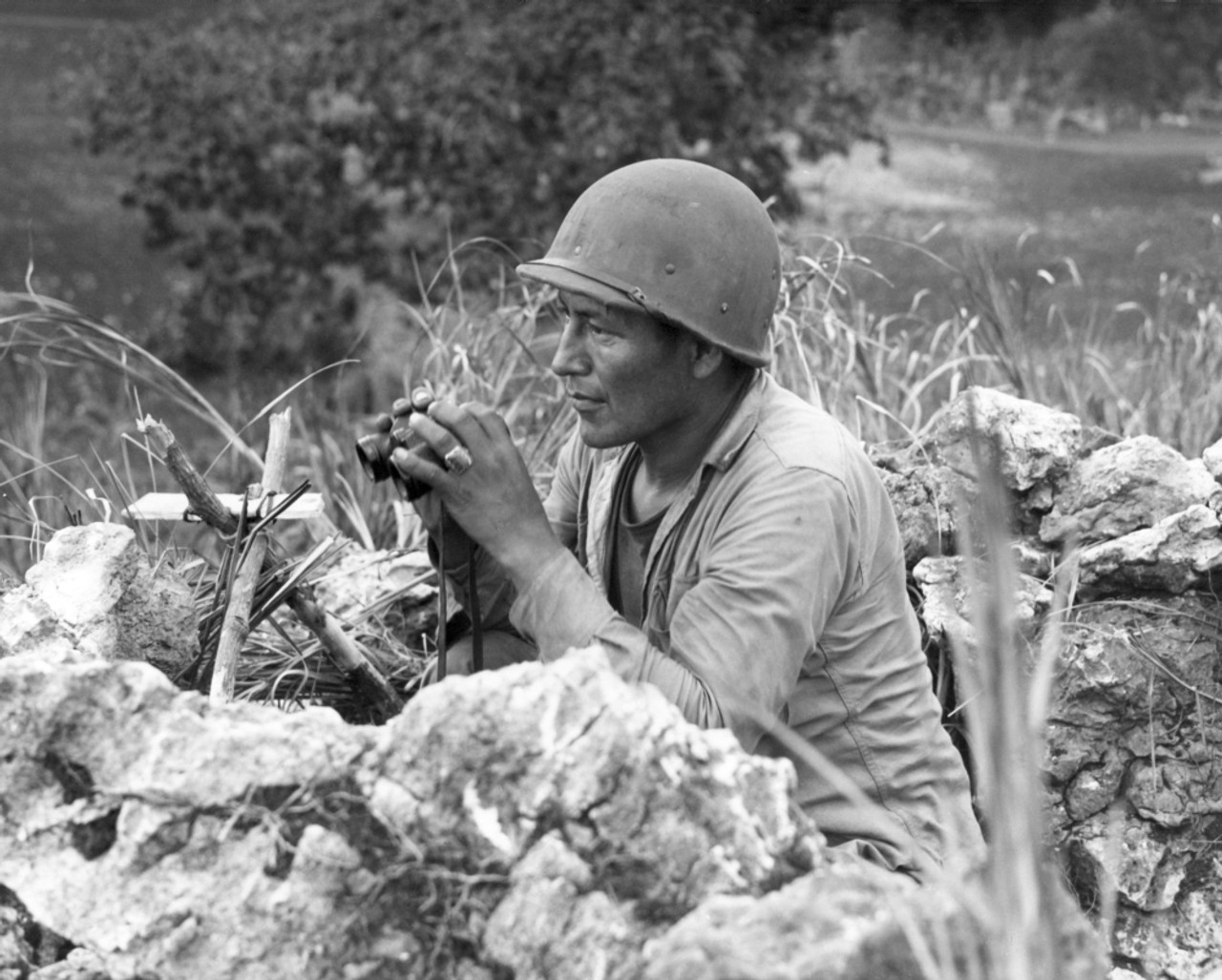A Native American Marine “Code Talker” at an observation post overlooking Garapan during the Battle of Saipan, June 27, 1944.