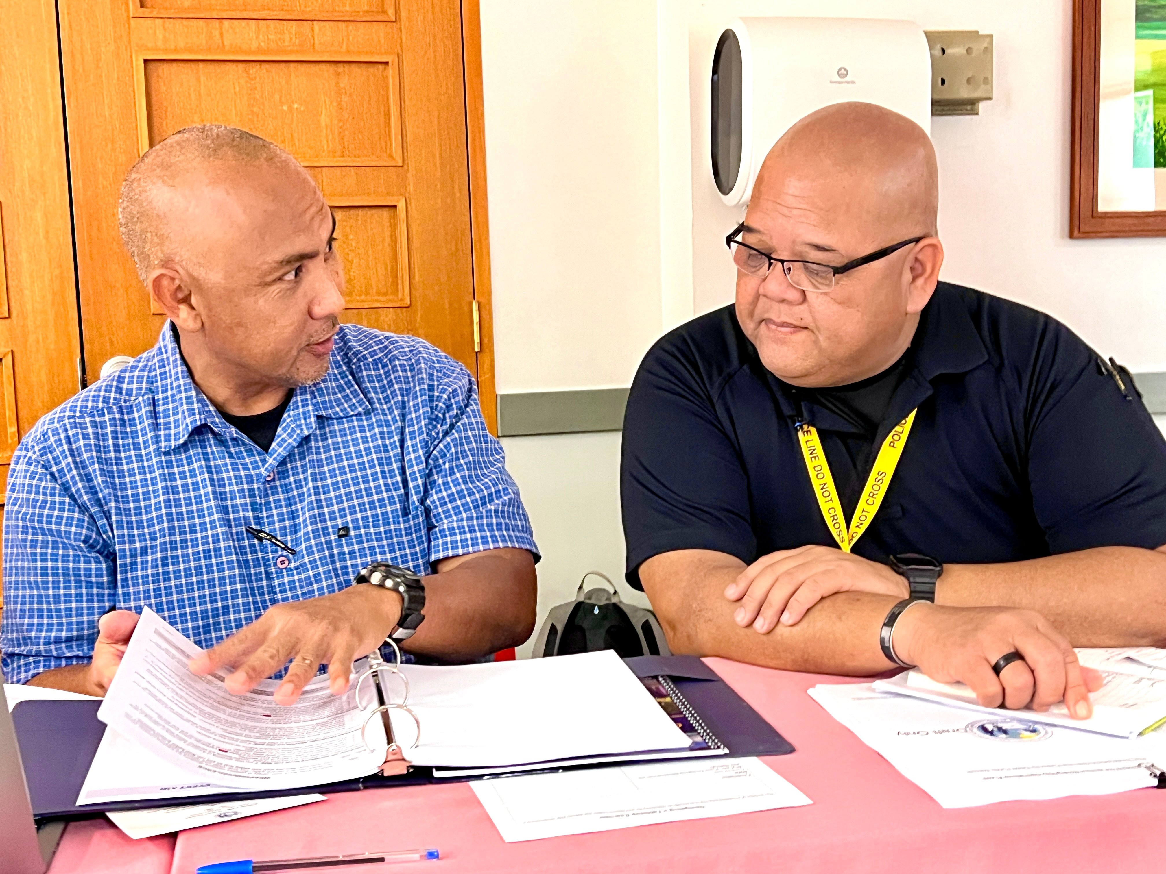 Acting Department of Public Safety Commissioner Anthony Macaranas, right, and PSS-Office of Pupil Transportation’s Joseph Muna, left, exchange ideas.