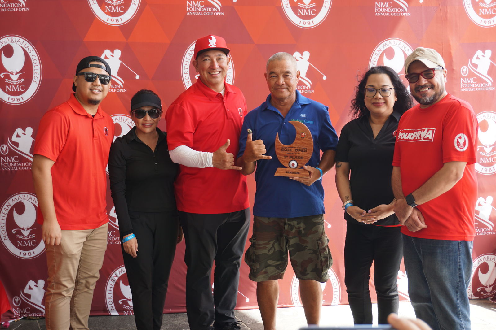 Joe "Kamikaze" Camacho holds the Senior Flight trophy as he poses for a photo with Northern Marianas College Foundation member Roman Tudela, Guam Hotel and Restaurant Association President Mary Rhodes, NMC Regent Dr. Jesse Tudela, NMC Regent Zenie Mafnas, and NMC President Galvin Deleon Guerrero, EdD, during the awards banquet of the NMC Foundation’s 19th Annual Golf Open at LaoLao Bay Golf & Resort on Sunday.