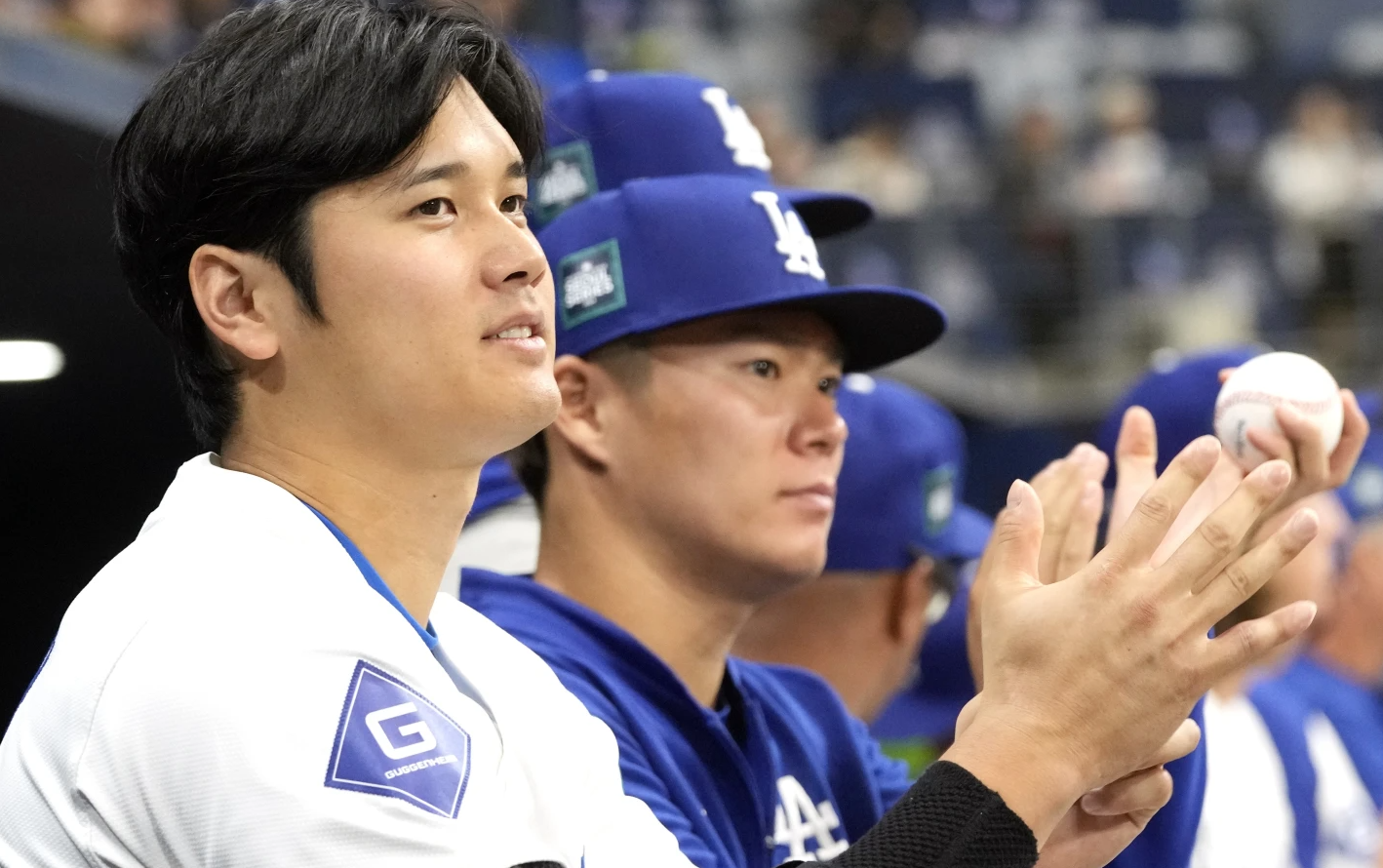 Los Angeles Dodgers’ designated hitter Shohei Ohtani, left, and pitcher Yoshinobu Yamamoto, right, applaud during an exhibition game between their team and the Kiwoom Heroes at the Gocheok Sky Dome in Seoul, South Korea, Sunday, March 17, 2024.