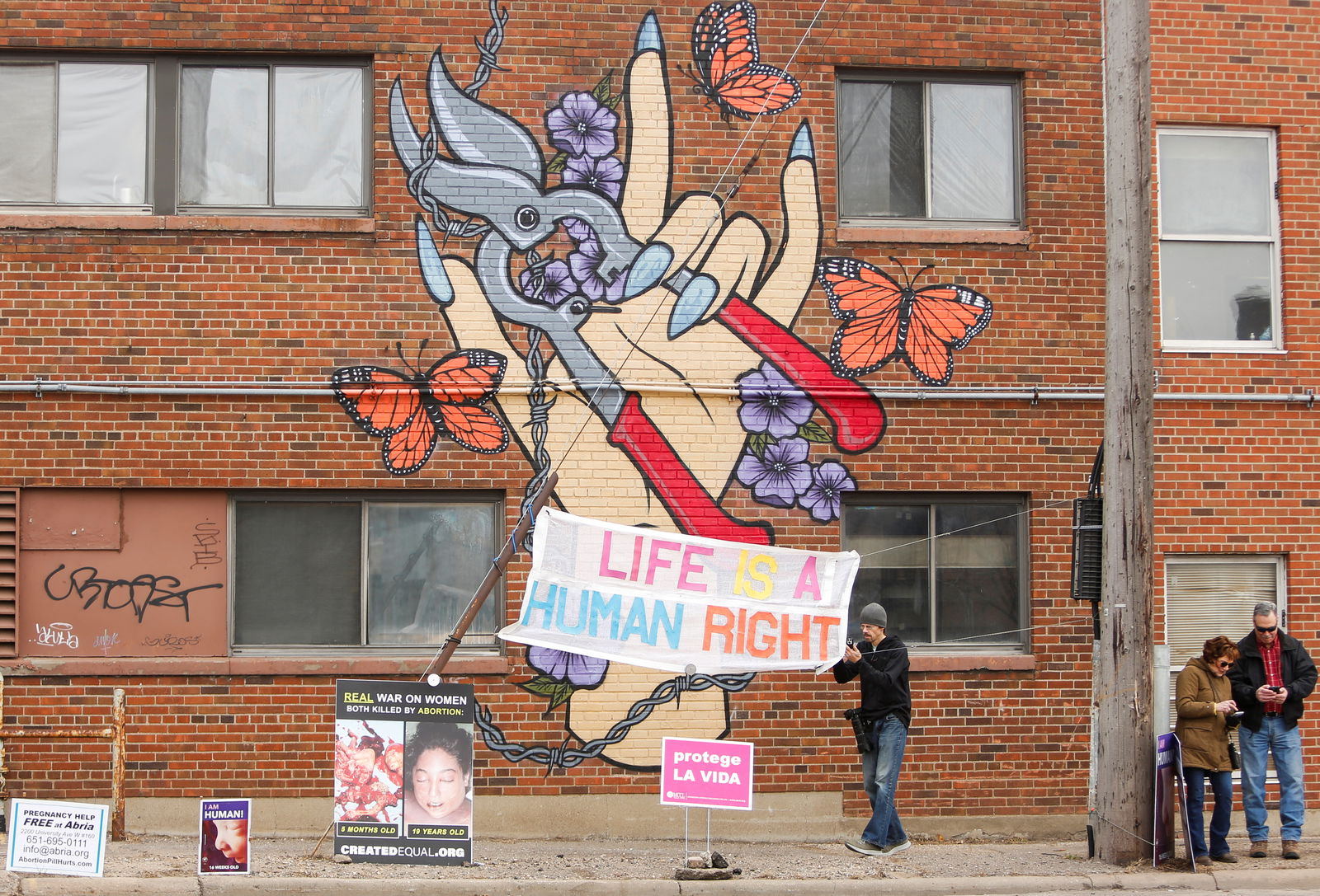 Signs against abortion are seen as U.S. Vice President Kamala Harris, visits the St. Paul Health Center, a clinic that performs abortions, in St. Paul, Minnesota, U.S., March 14, 2024. 