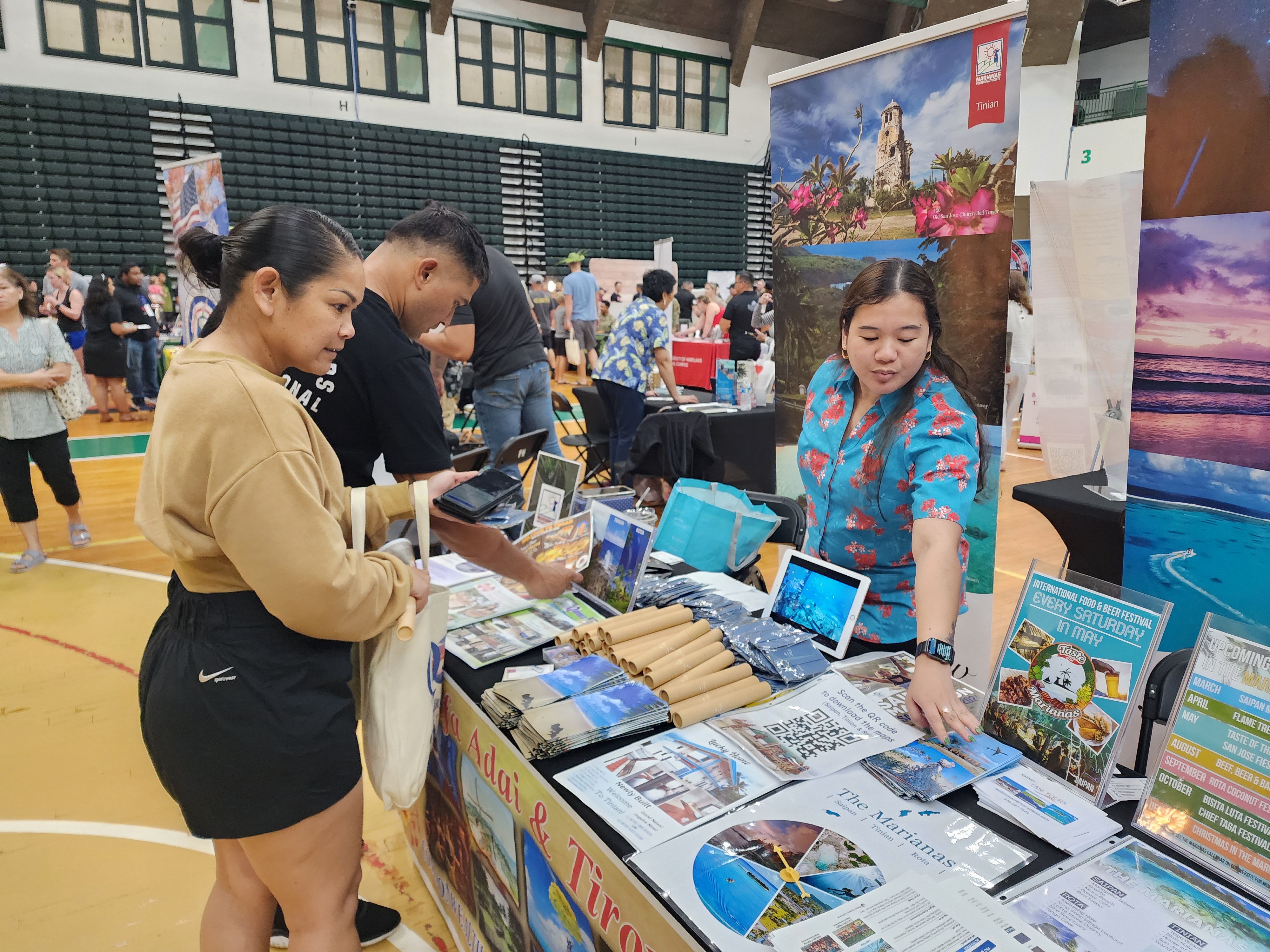 Zenella Sablan, right, of the Marianas Visitors Authority shares information about the Marianas at the Quality of Life EXPO 2024 on Feb. 24, 2024, at the University of Guam. The travel show was organized by Joint Region Marianas to showcase regional resources and services to military service members and their families.