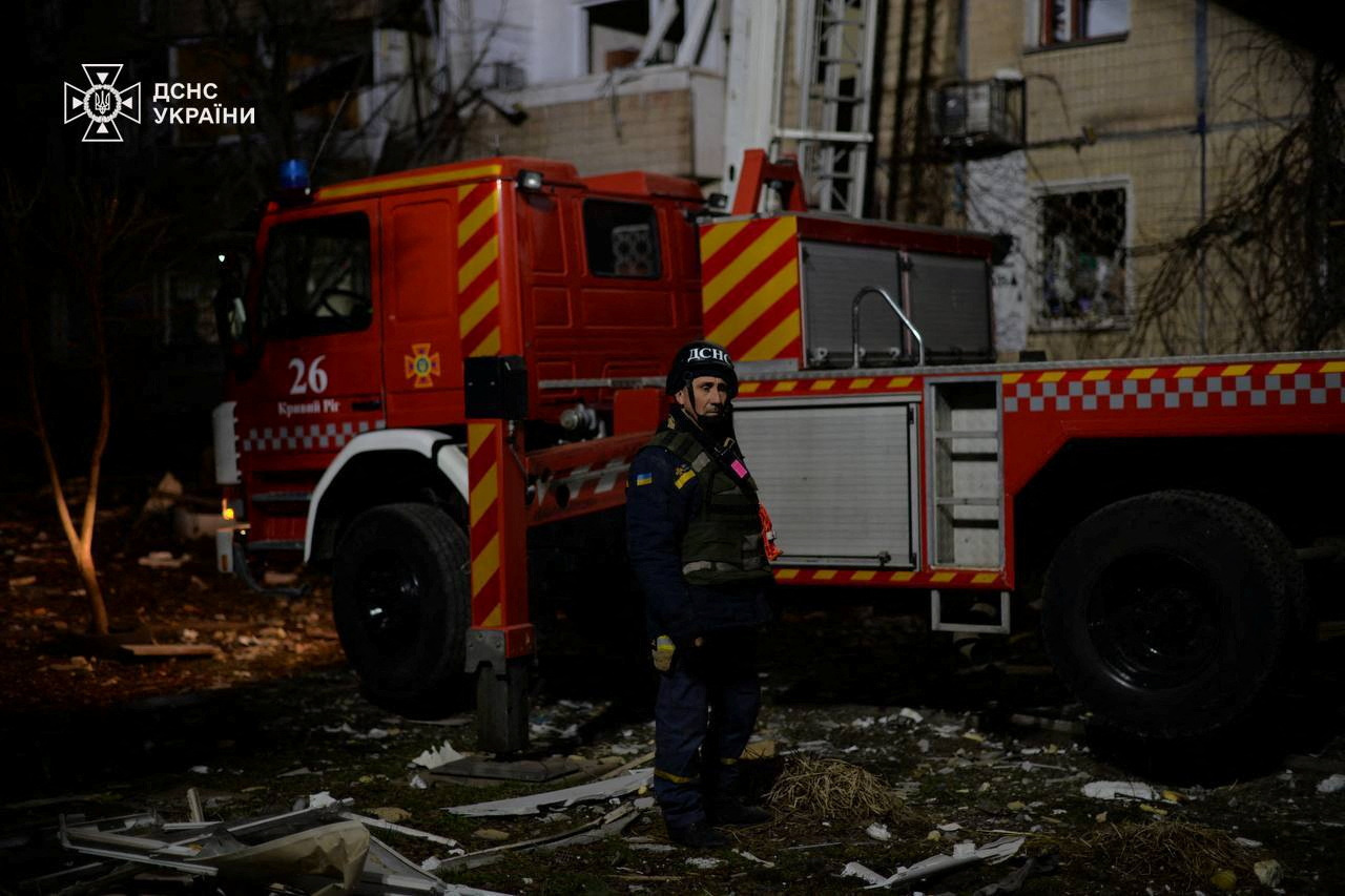 A member of the emergency services works after a Russian missile slammed into two apartment buildings in the central Ukrainian city of Kryvyi Rih, March 12, 2024. 