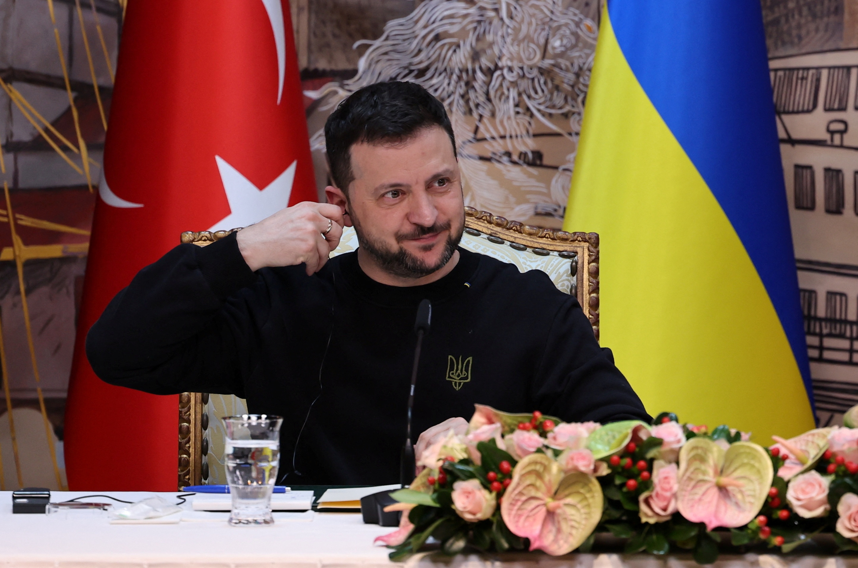 Ukrainian President Volodymyr Zelenskiy adjusts his earphone during a press conference with his Turkish counterpart Tayyip Erdogan (not pictured) in Istanbul, Turkey, March 8, 2024. 