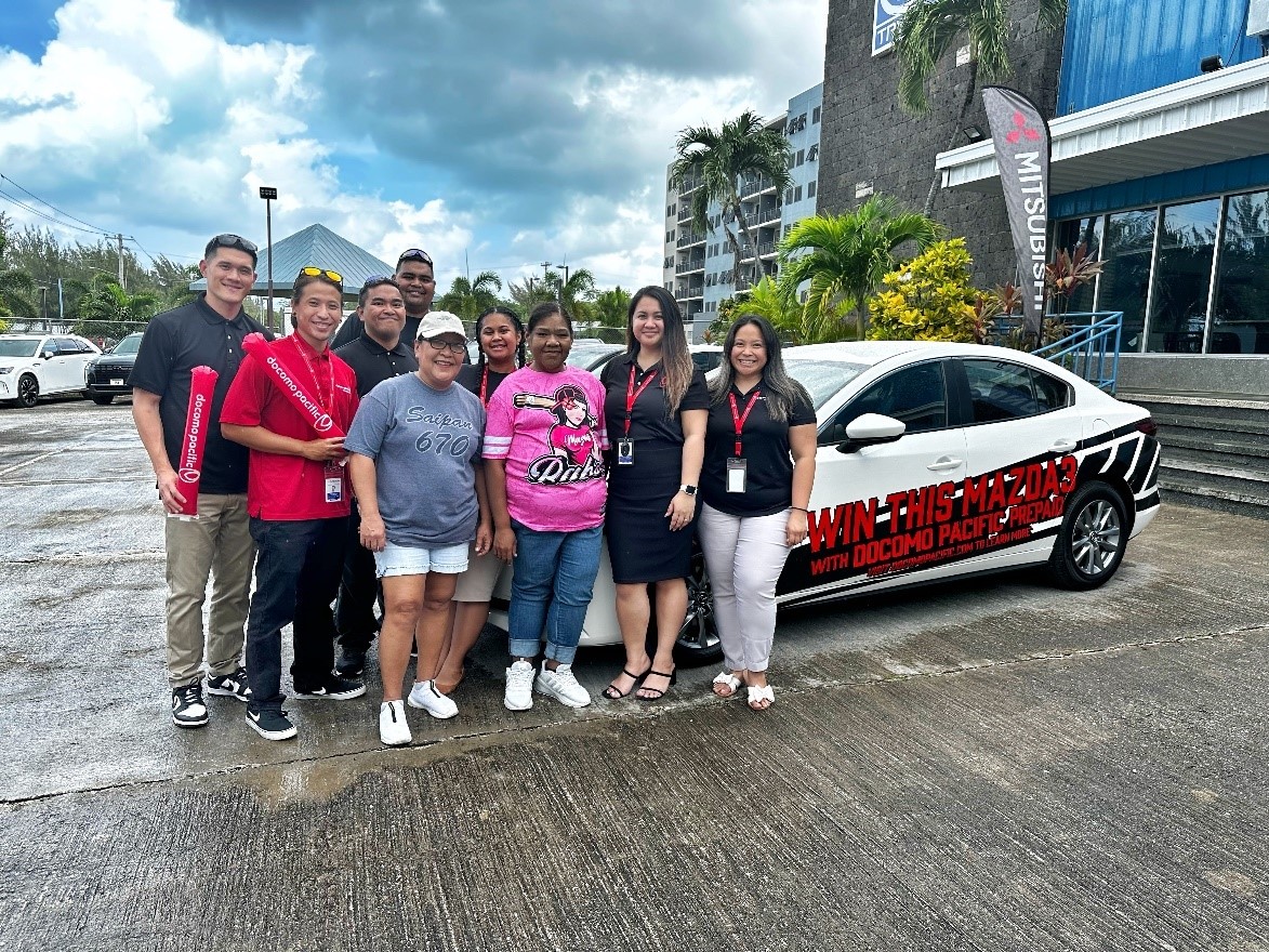 From left, Shane Deleon Guerrero, store manager, Docomo Pacific; Peter Matagolai Jr. production artist, Docomo Pacific; Joaquin Duenas and Richard Mendiola, prepaid coordinators, Docomo Pacific; Damali Wasser, direct sales representative, Docomo Pacific; Kikulane Pangelinan, 2024 Docomo Pacific prepaid car giveaway winner; Therese Santos, customer service representative lead, Docomo Pacific; and Nicole Babauta, senior consumer manager, Docomo Pacific.