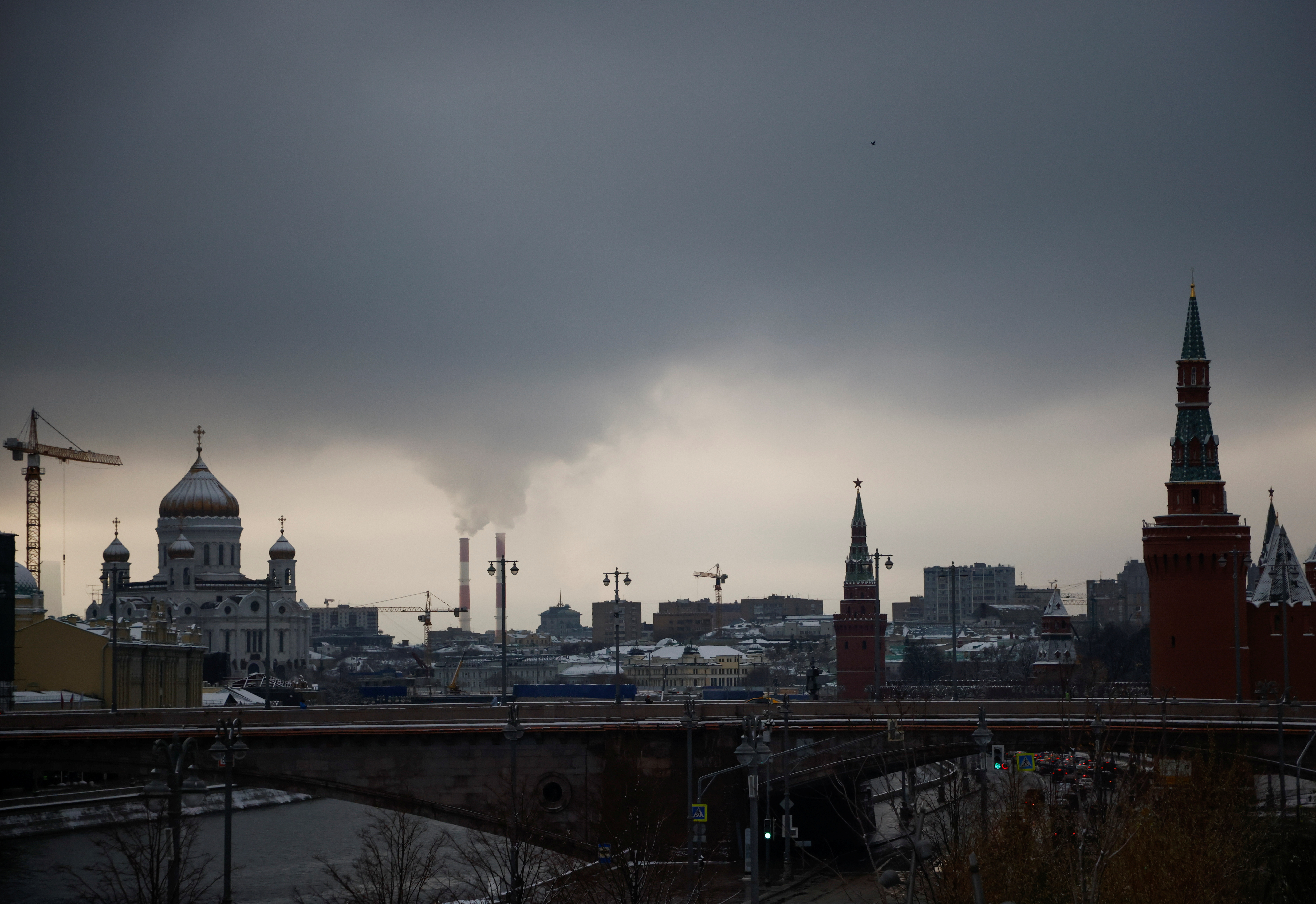 FILE PHOTO: Steam rises from chimneys of a heating power plan over the skyline of central Moscow, Russia November 23, 2020. 