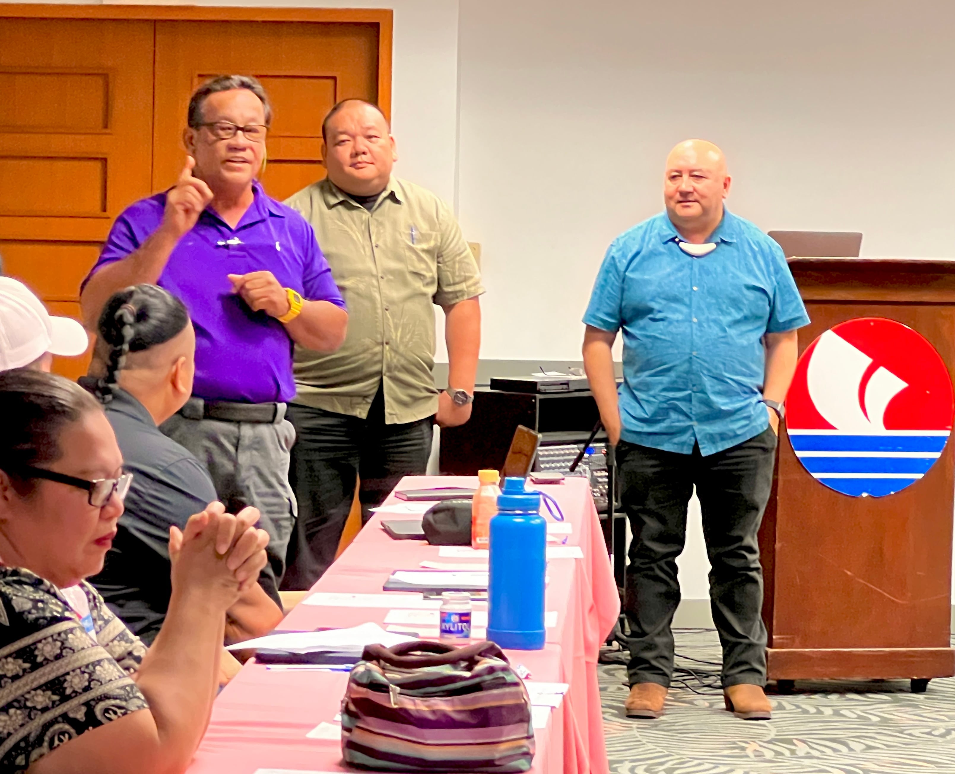 Saipan Mayor RB Camacho stresses a point while Commissioner of Education Dr. Lawrence F. Camacho and Associate Commissioner for Administrative Services Eric Magofna, along with other agency partners, listen.