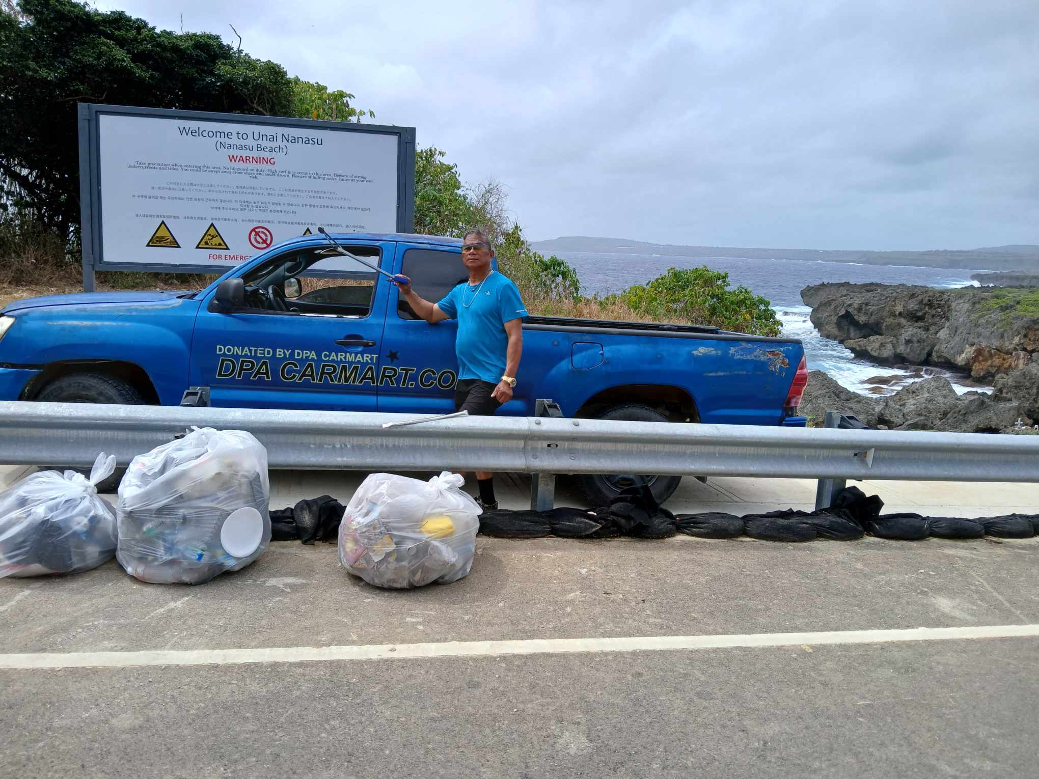 Community volunteer Max Aguon picked up trash at Nanasu Beach on Windward Road, Sunday.