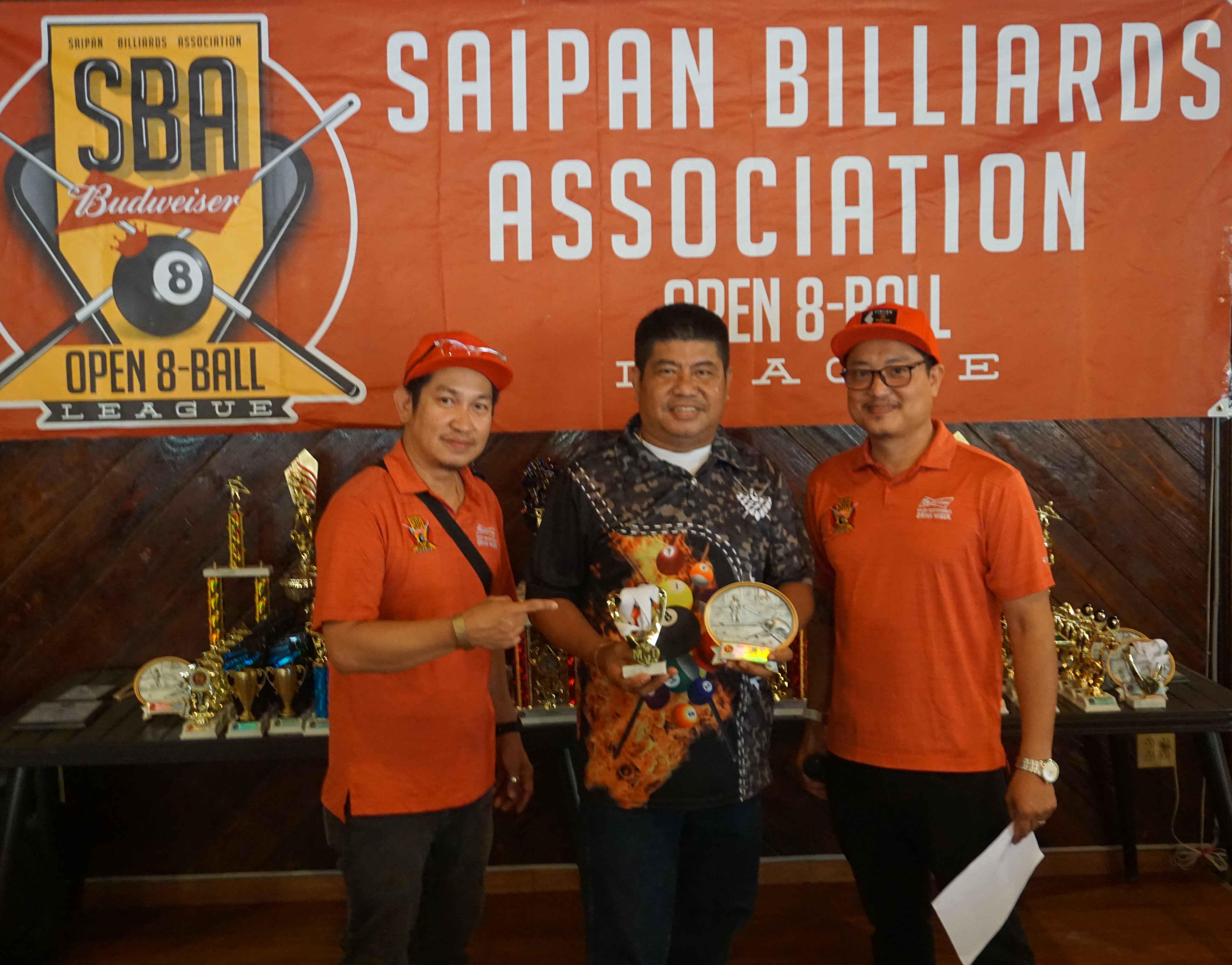 Jerry Soriano holds the MVP elimination round trophy as he poses for a photo with league secretary Ivan Sales and assistant league secretary Ray Naluz during the awards banquet of the 2023 SBA Budweiser Open 8-Ball League at the West Coast Restaurant on Sunday.