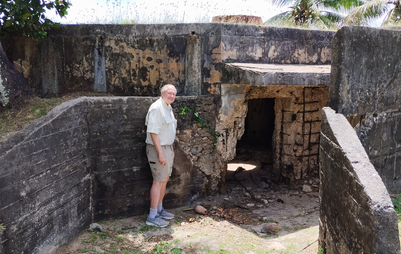In his father's footsteps: Alan Sonntag (2024) stands exactly where Herman Sonntag (1944) stood at the Obyan Beach blockhouse on Saipan — creating a special eight-decade connection between father and son.