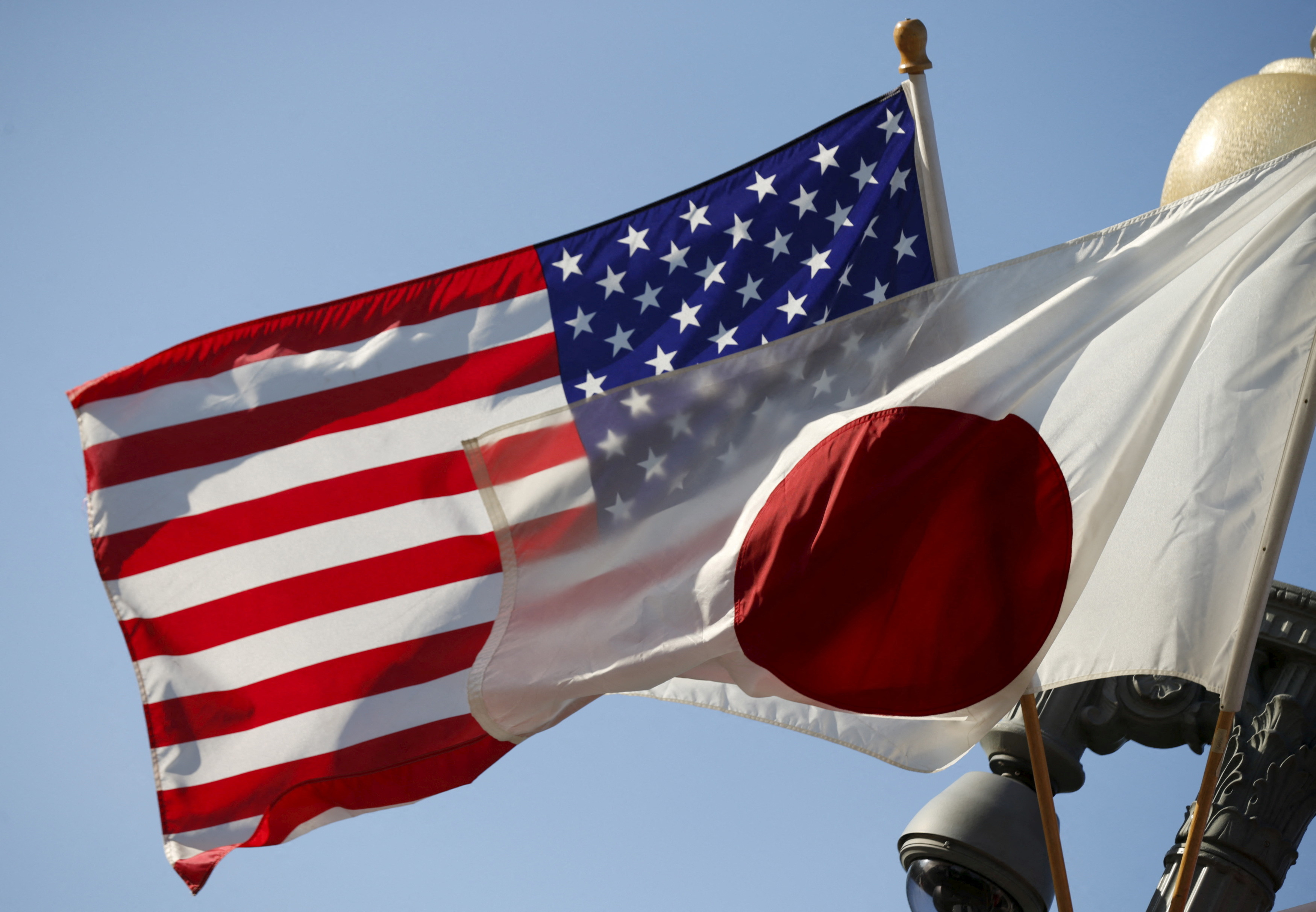 FILE PHOTO: The U.S. and Japan flags fly together outside the White House in Washington April 27, 2015. 