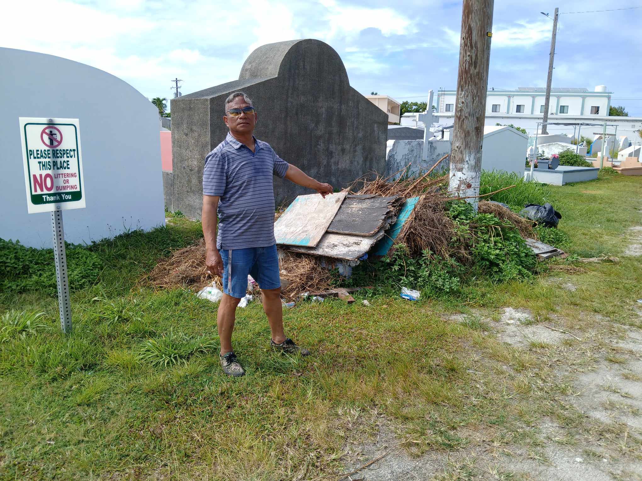 Max Aguon points to the illegally dumped trash at the CK cemetery.