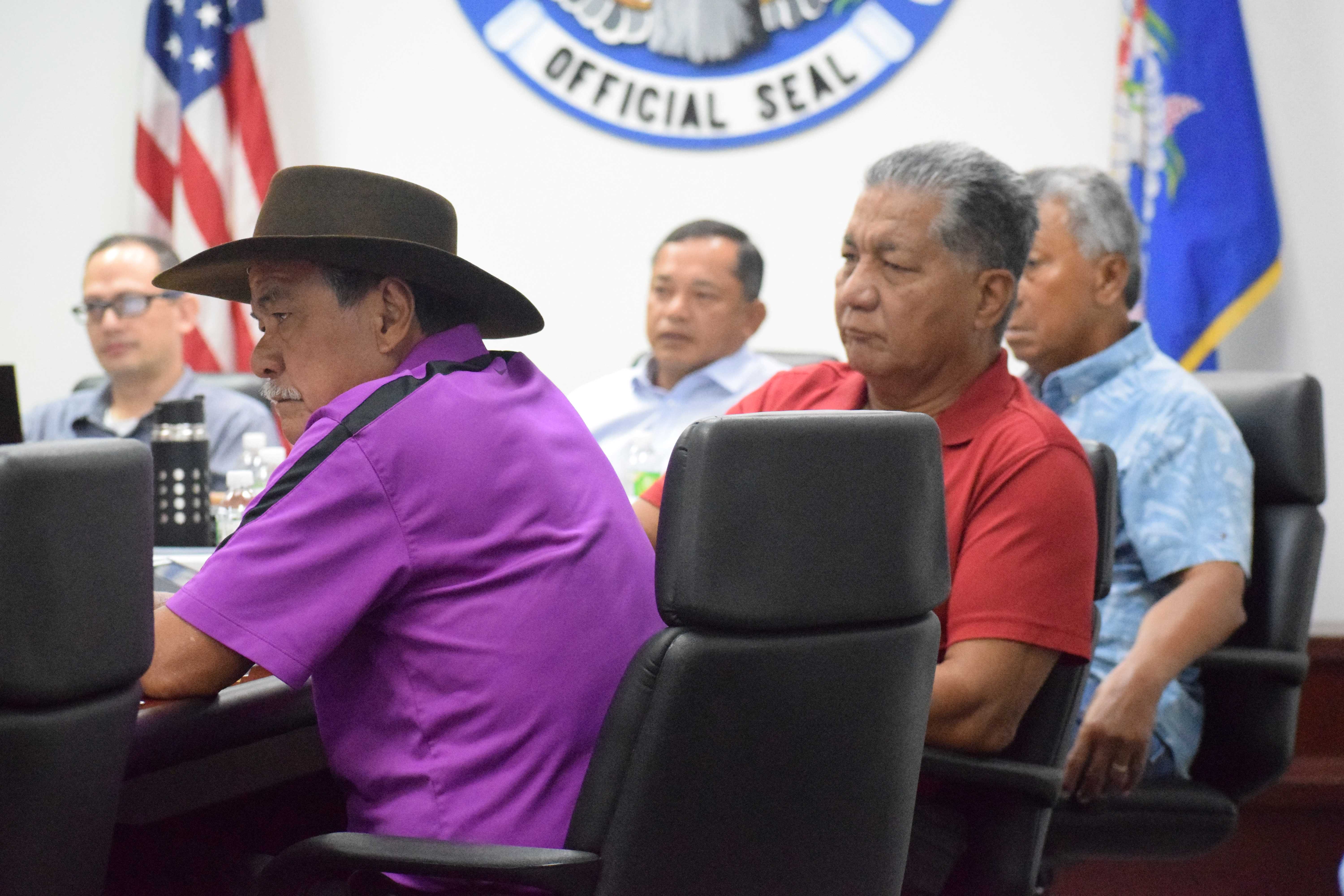 Commissioners Ramon Dela Cruz, Ralph Demapan, Martin Mendiola and Mario Taitano, and their counsel, Carl Dela Cruz, left, listen during the revocation hearing at the administration building on Capital Hill.