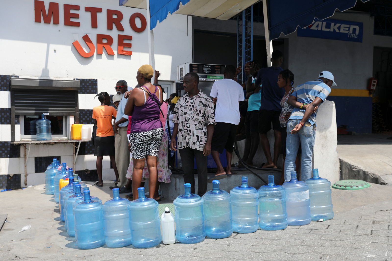 Residents buy drinking water as the government said it would extend a state of emergency for another month after an escalation in violence from gangs seeking to oust the Prime Minister Ariel Henry, in Port-au-Prince, Haiti, March 7, 2024. 