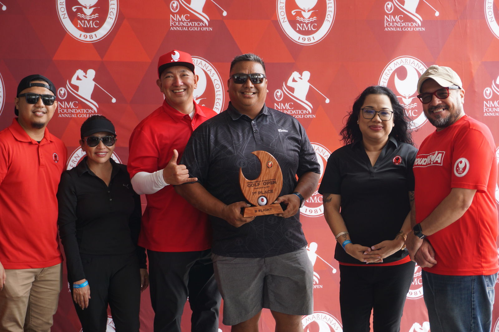 Carl Hocog holds the B Flight trophy as he poses for a photo with Northern Marianas College Foundation member Roman Tudela, Guam Hotel and Restaurant Association President Mary Rhodes, NMC Regent Dr. Jesse Tudela, NMC Regent Zenie Mafnas, and NMC President Galvin Deleon Guerrero, EdD, during the awards banquet of the NMC Foundation’s 19th Annual Golf Open at LaoLao Bay Golf & Resort on Sunday.