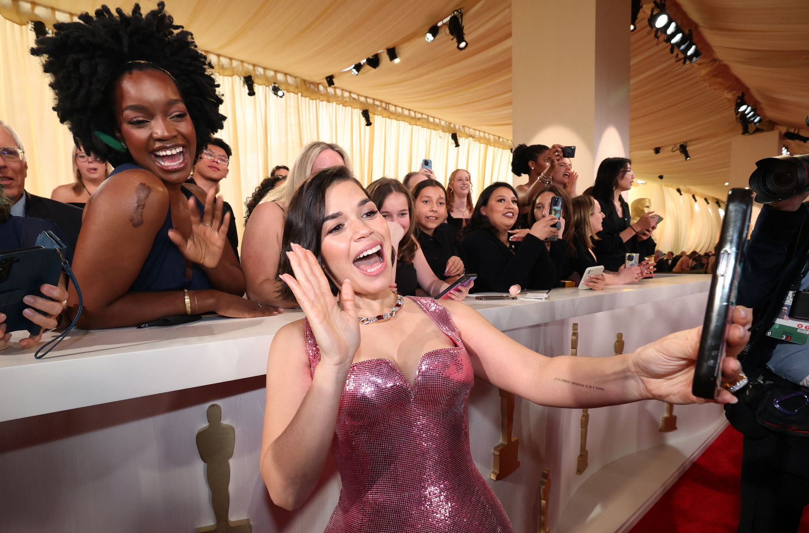 America Ferrera poses for a photograph with spectators on the red carpet during the Oscars arrivals at the 96th Academy Awards in Hollywood, Los Angeles, California, U.S., March 10, 2024. 