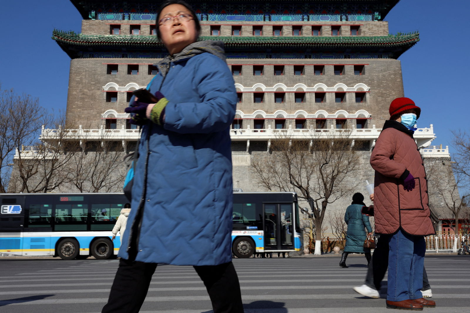 Pedestrians walk on a crossing near the Qianmen Gate in Beijing, China on January 26, 2024. 
