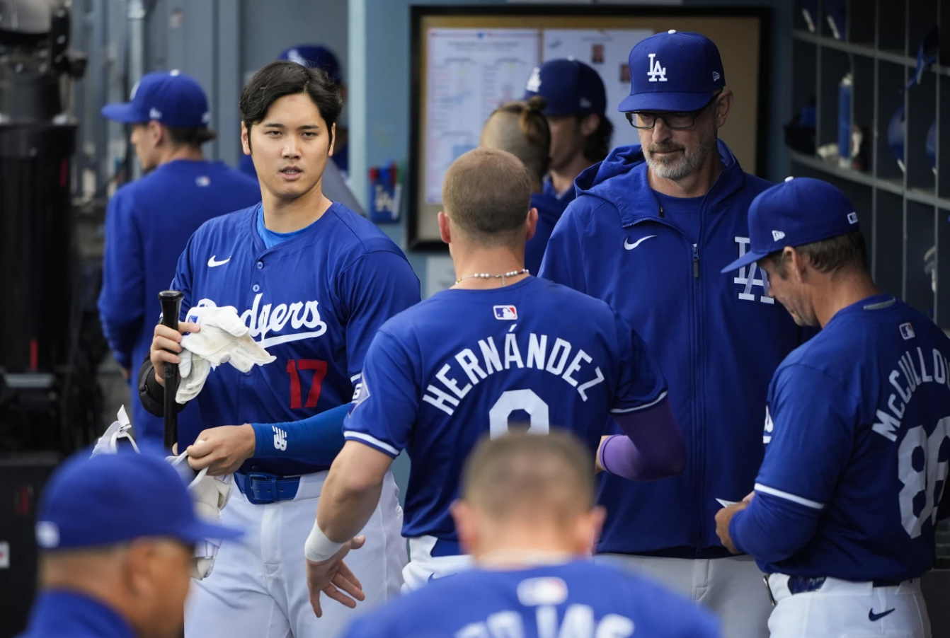 Los Angeles Dodgers’ Shohei Ohtani walks across the dugout during the first inning of a spring training baseball game against the Los Angele Angels Monday, March 25, 2024 in Los Angeles.