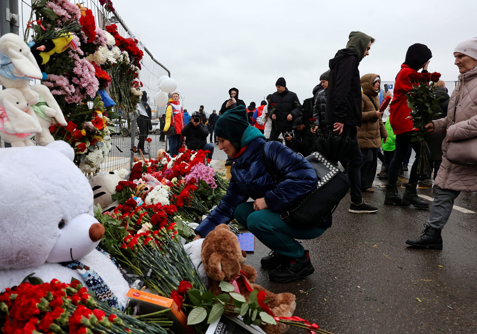 People lay flowers at a makeshift memorial to the victims of a shooting attack at the Crocus City Hall concert venue in the Moscow Region, Russia, March 23, 2024. 