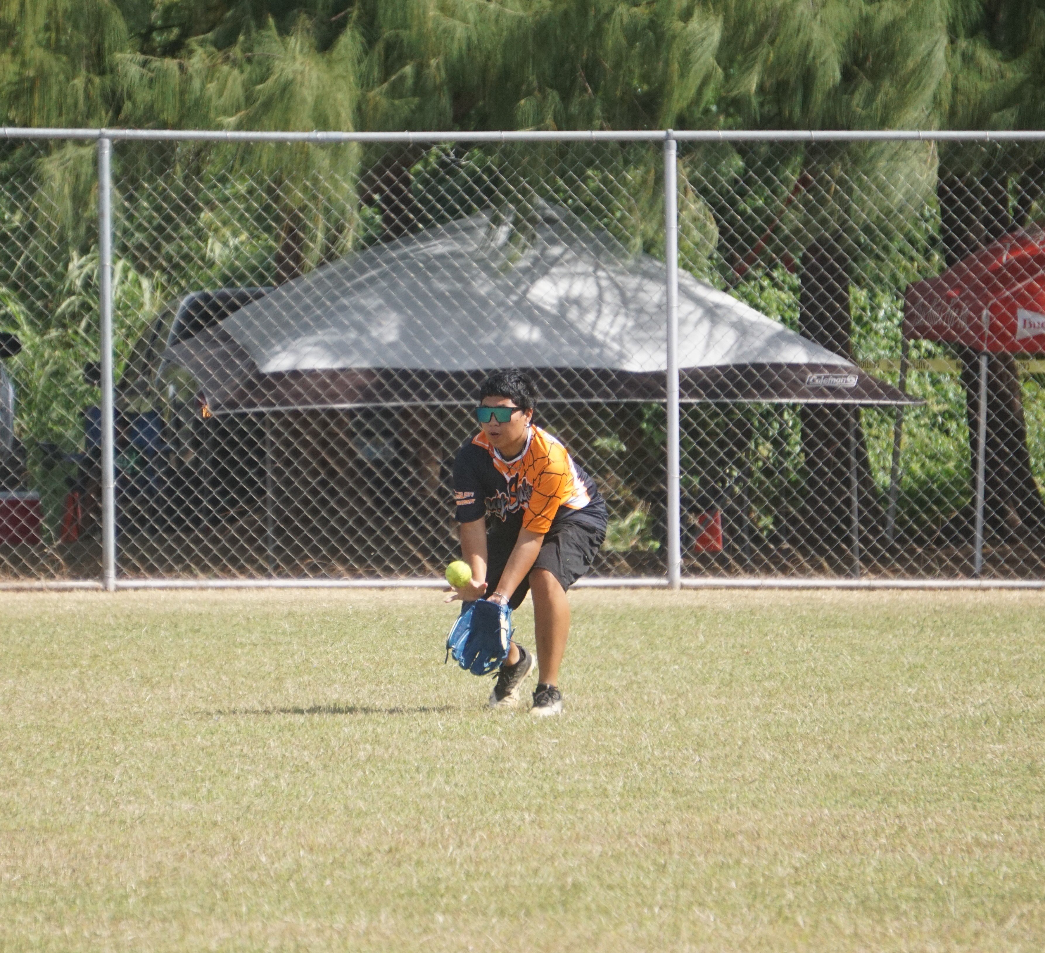 Lady SUFA's Bong Babauta secures the grounder during a women's division game of the 2024 Budweiser Belau Amateur Softball Association League at the Dandan baseball field.