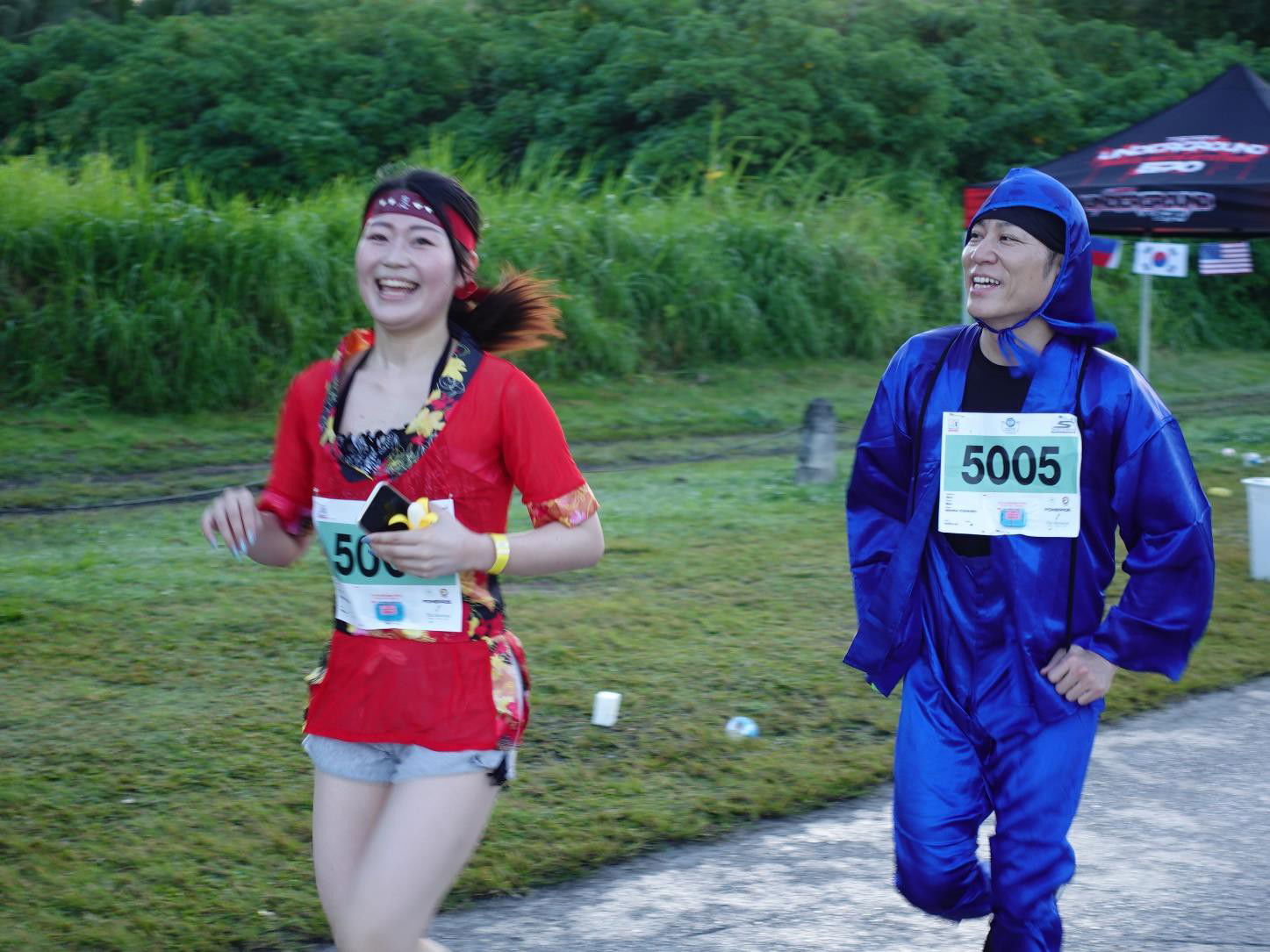 Atusko Yoshimi and Yoshiko Nishida of Japan enjoy a little wackiness in the Skechers Saipan Marathon 2024 on March 9.