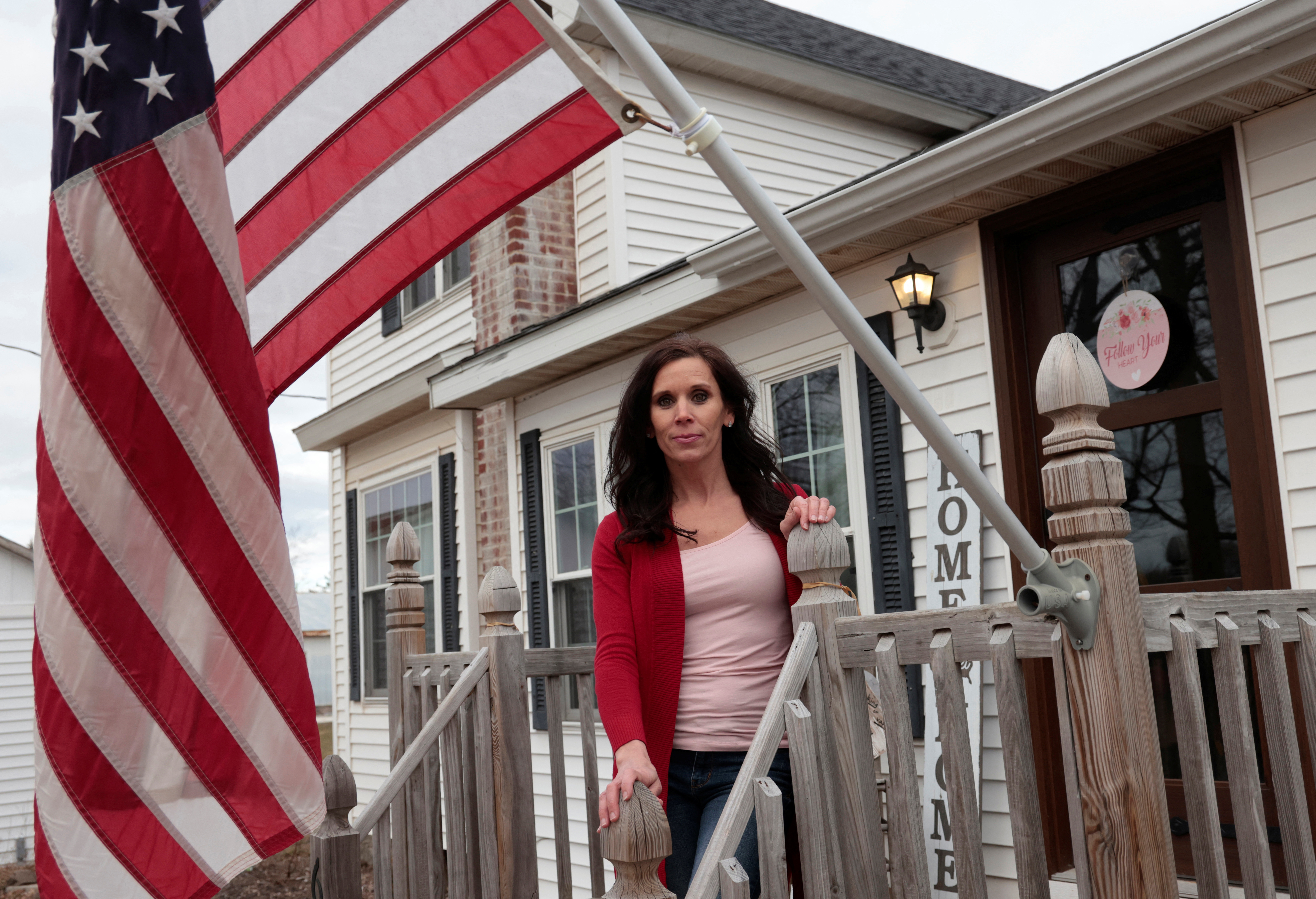 Michigan Republican Bree Moeggenberg poses next to an American flag in front of her home in Mount Pleasant, Michigan, U.S. February 14, 2024. 