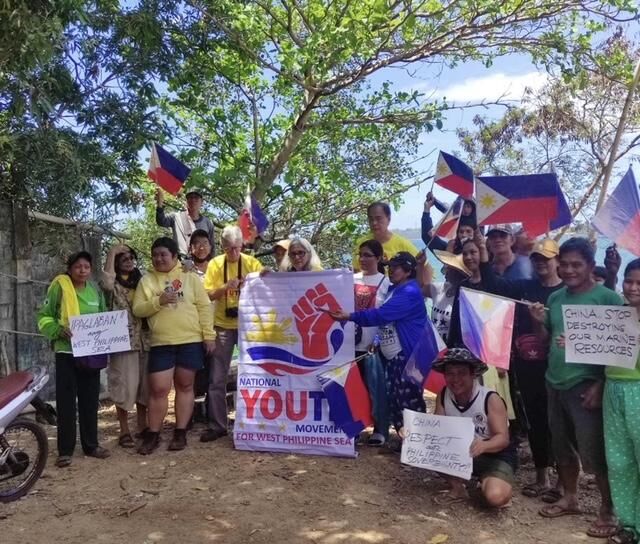 Scarborough Shoal fisherfolk and families as well as NYMWPS members are asking the Filipino people to fight for the West Philippine Sea. They are also demanding that China respect Philippine sovereignty, stop destroying Philippine marine resources and to get out of the West Philippine Sea. In photo are Dr. Celia Lamkin, NYMWPS founder and global chair, holding the NYMWPS banner; Capt. Caruso M. Tagal, NYMWPS director of membership; Professor Ron Lamkin, NYMWPS member and adviser; and Via Tagal, NYMWPS multimedia officer.