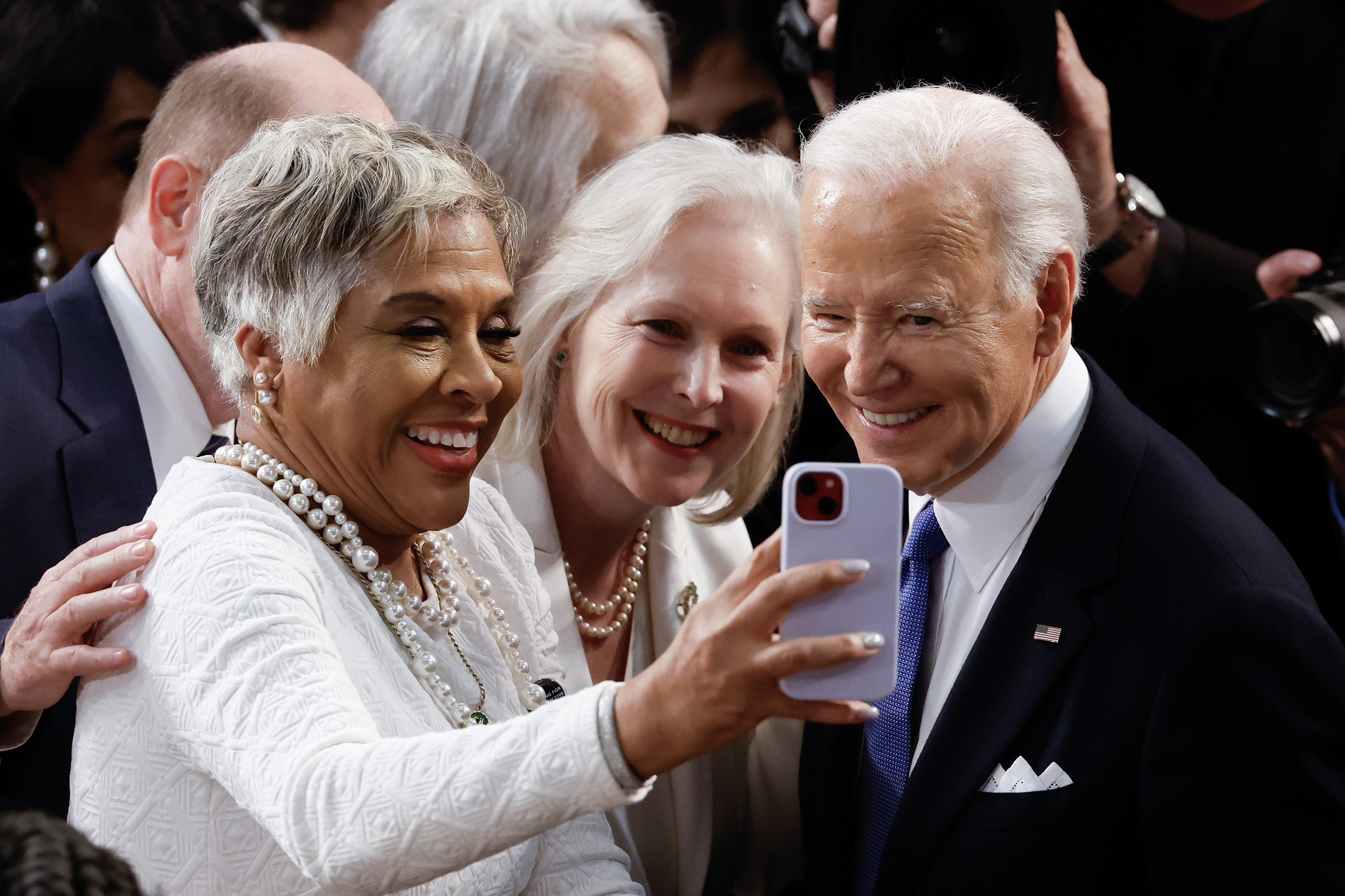 President Joe Biden takes a photo with Sen. Kristen Gillibrand (D-NY), middle, and Rep. Joyce Beatty (D-OH) as he arrives to deliver the State of the Union address during a joint meeting of Congress in the House chamber at the U.S. Capitol on March 7, 2024, in Washington, D.C. (Chip Somodevilla/Getty Images/TNS)