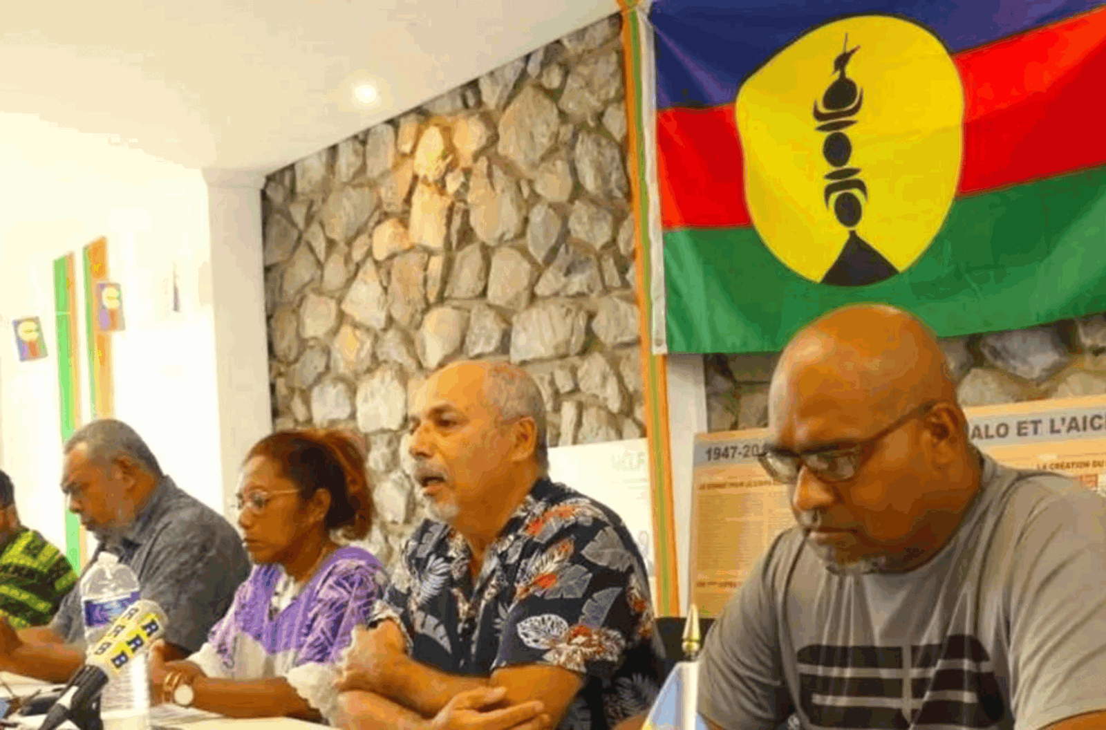 New Caledonia's pro-independence Union Calédonienne's spokesman Gilbert Tyuienon (centre) speaks to the media during a press conference