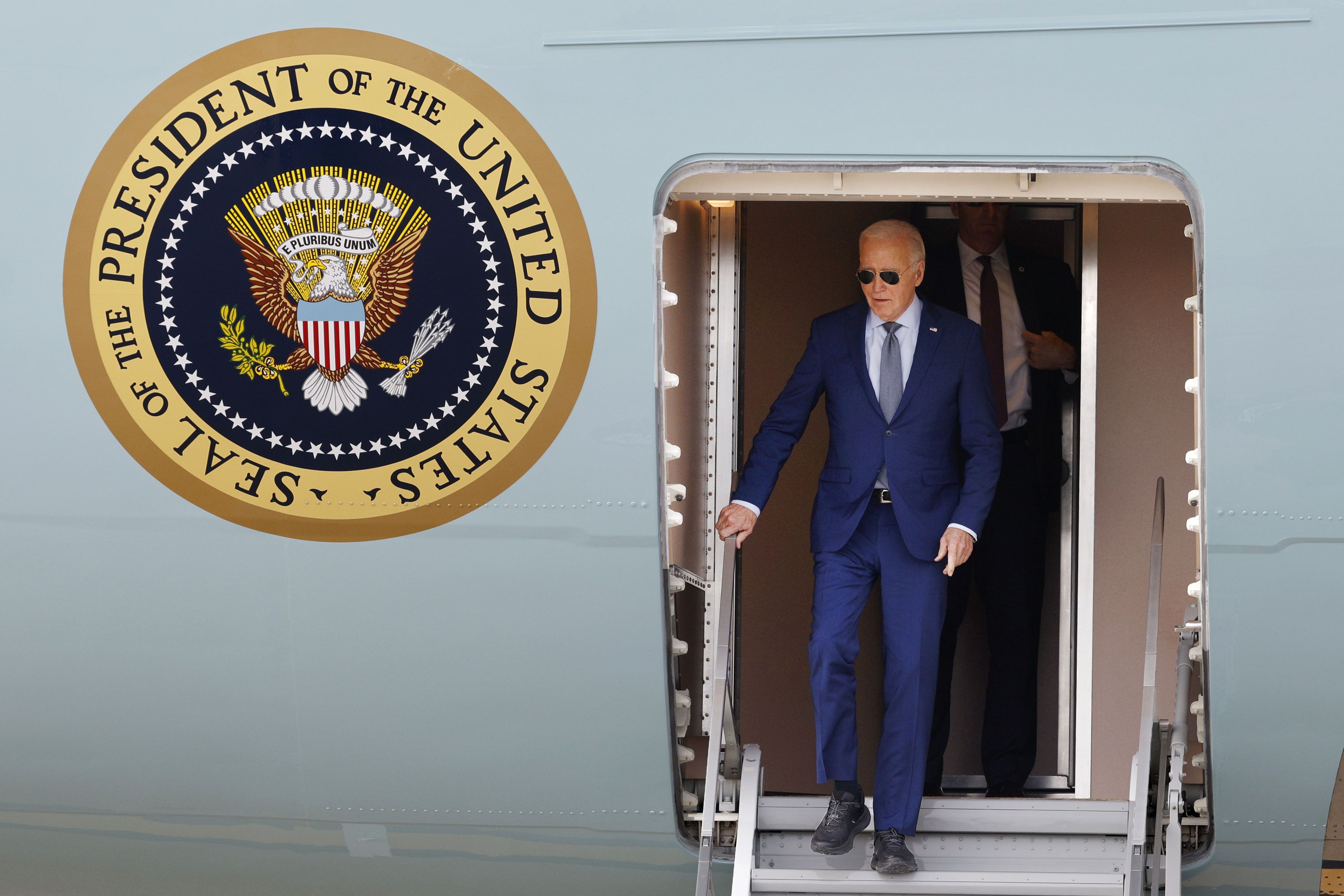 President Joe Biden walks down the steps of Air Force One upon arrival at Dallas Fort Worth International Airport, Wednesday, March 20, 2024.