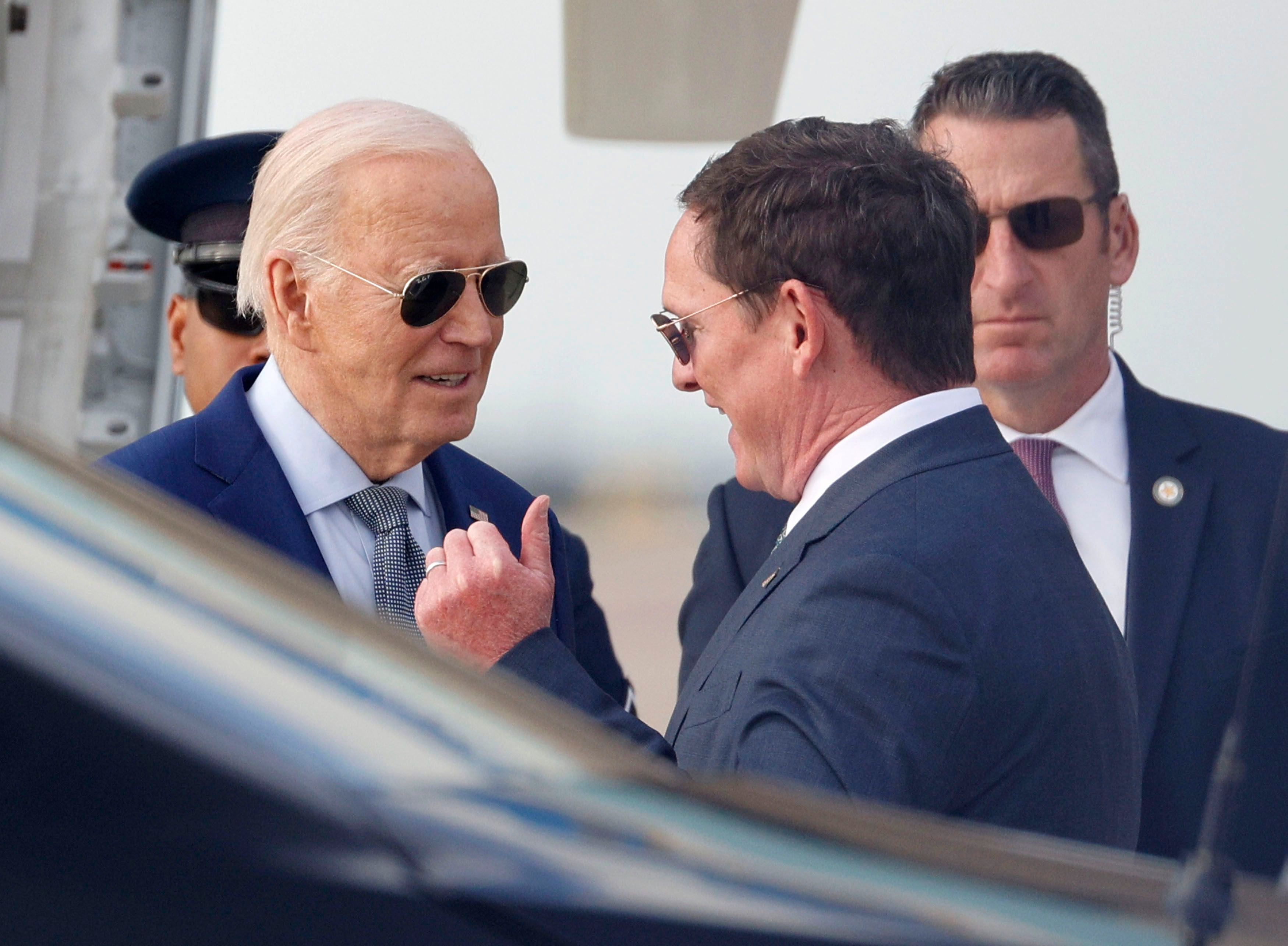 President Joe Biden, left, talks with Dallas County Judge Clay Lewis Jenkins upon his arrival at Dallas Fort Worth International Airport, Wednesday, March 20, 2024.