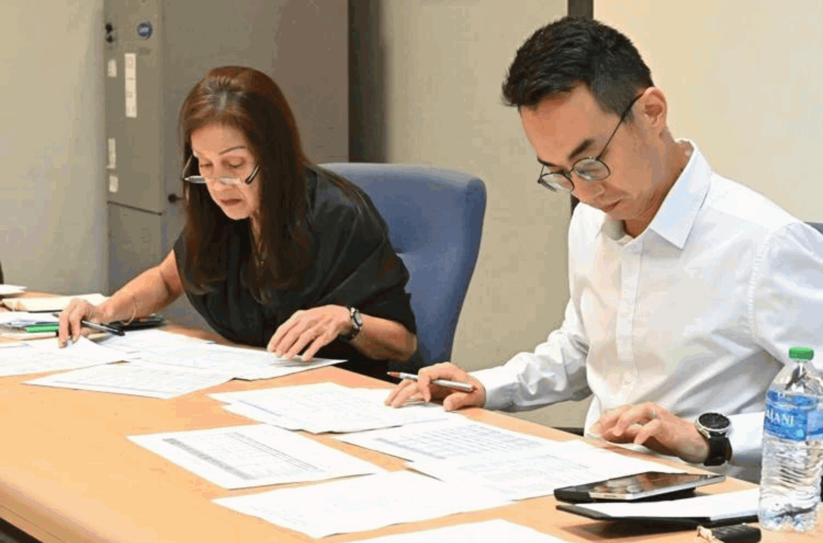 Guam Department of Education Deputy Superintendent of Finance and Administrative Services Joann Camacho, left, and controller Moonsu "Adam" Shin look over financial reports during a meeting on Thursday, Jan. 25, 2024, in Tiyan. 
