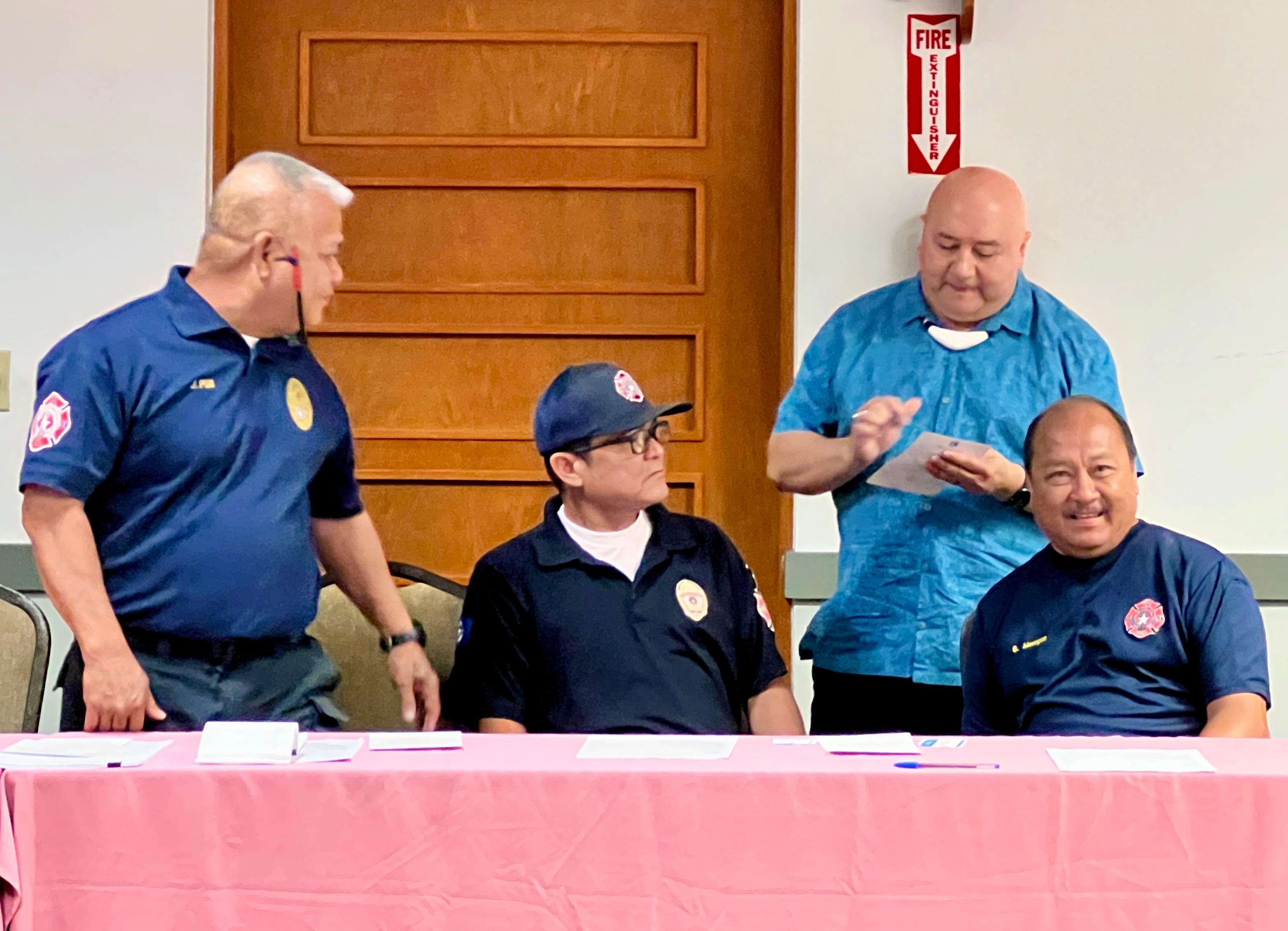 Department of Fire and Emergency Management Services Deputy Secretary Steve Mesgnon, seated right, and his team, with Commissioner of Education Dr. Lawrence F. Camacho.