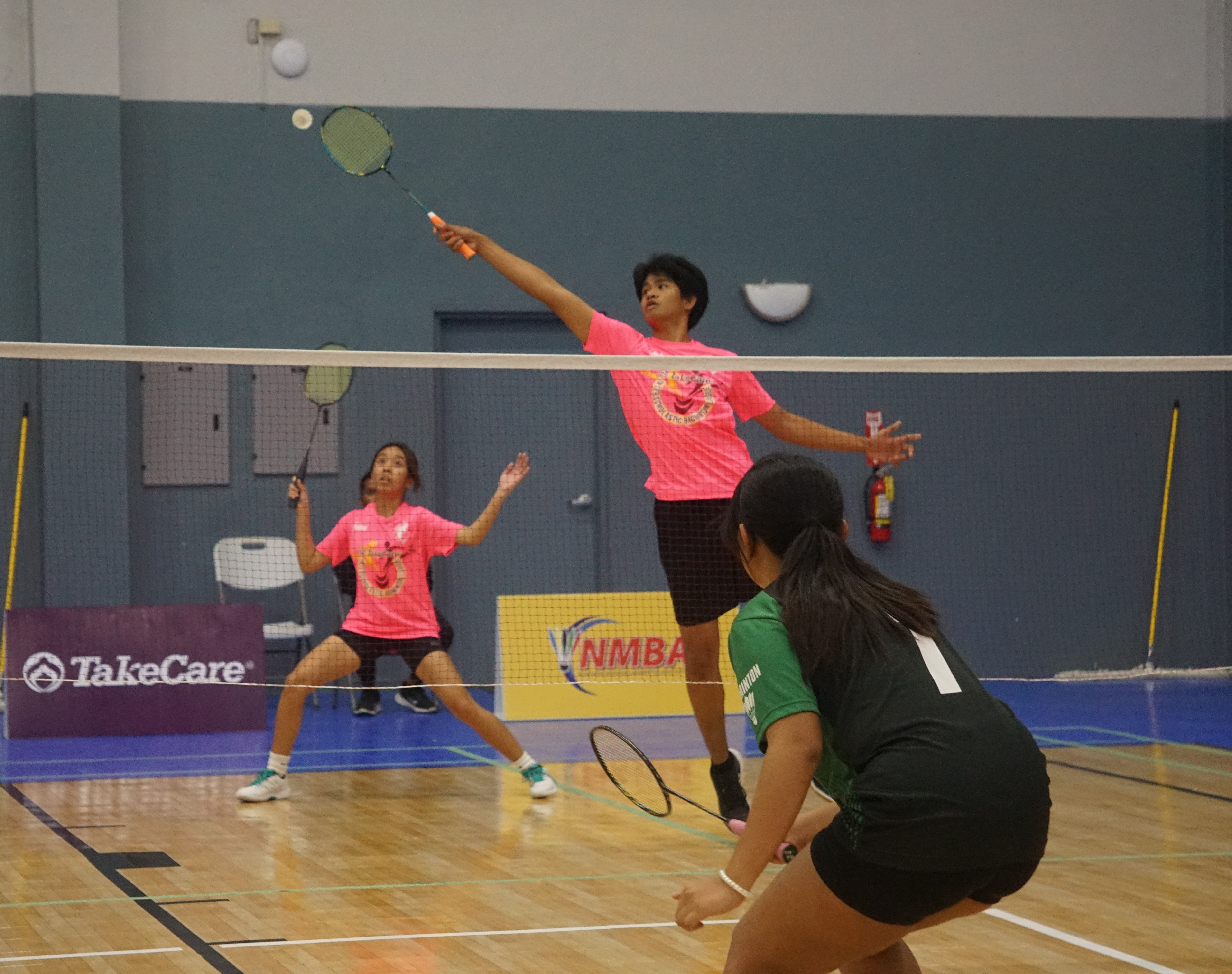 MHS' Bradon Manacop extends for the return as teammate Abigael Robles covers from behind during a Mixed Doubles game against MHS in the co-ed high school division championship of the NMBA-PSS Interscholastic Badminton League SY23-24 at the Ada gym on Saturday. 