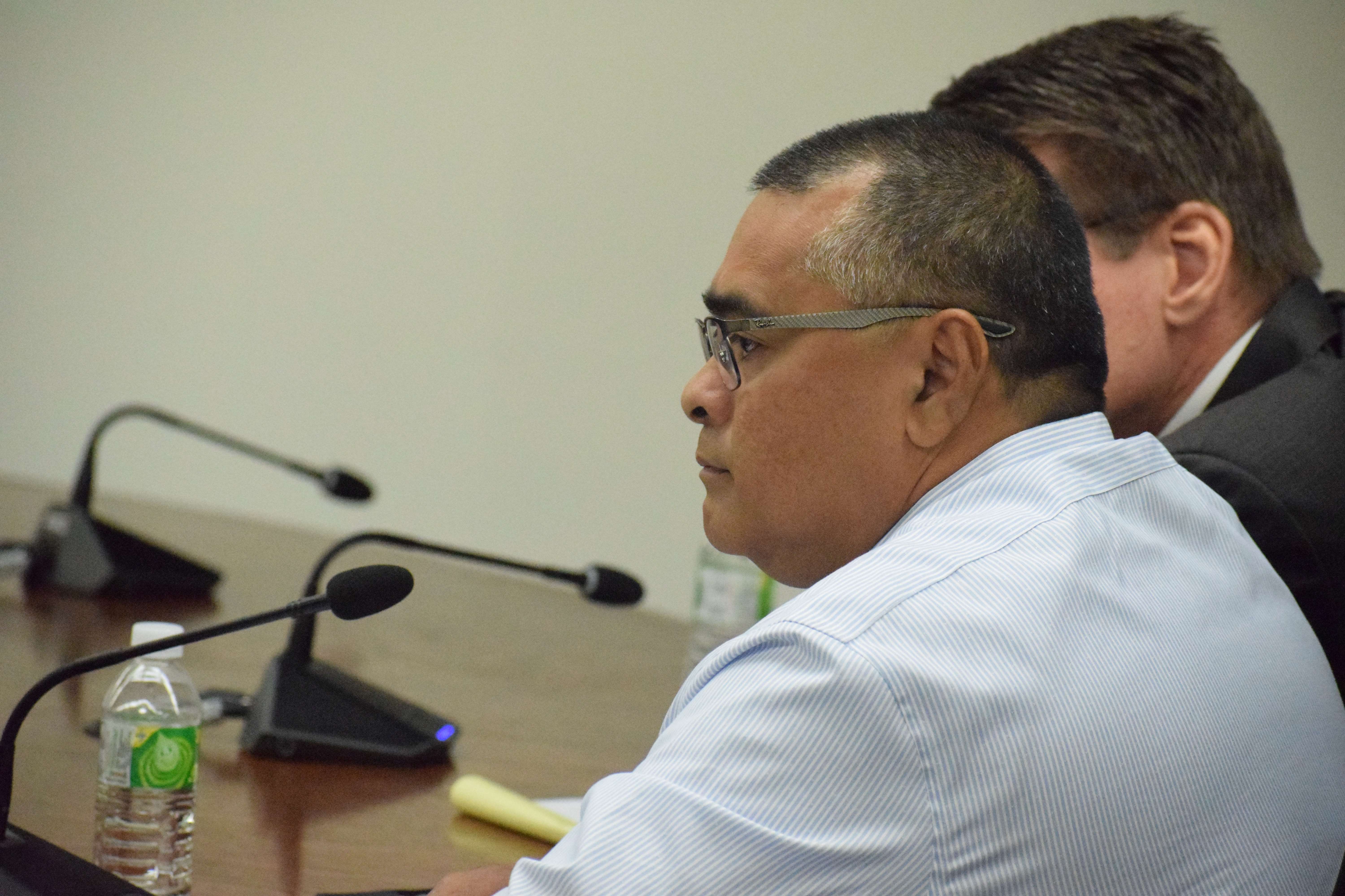 Former Finance Secretary David DLG Atalig looks at an exhibit displayed on a computer monitor in front of him during a meeting with the House Special Committee on Federal Assistance & Disaster-Related Funding in the House chamber on Tuesday.