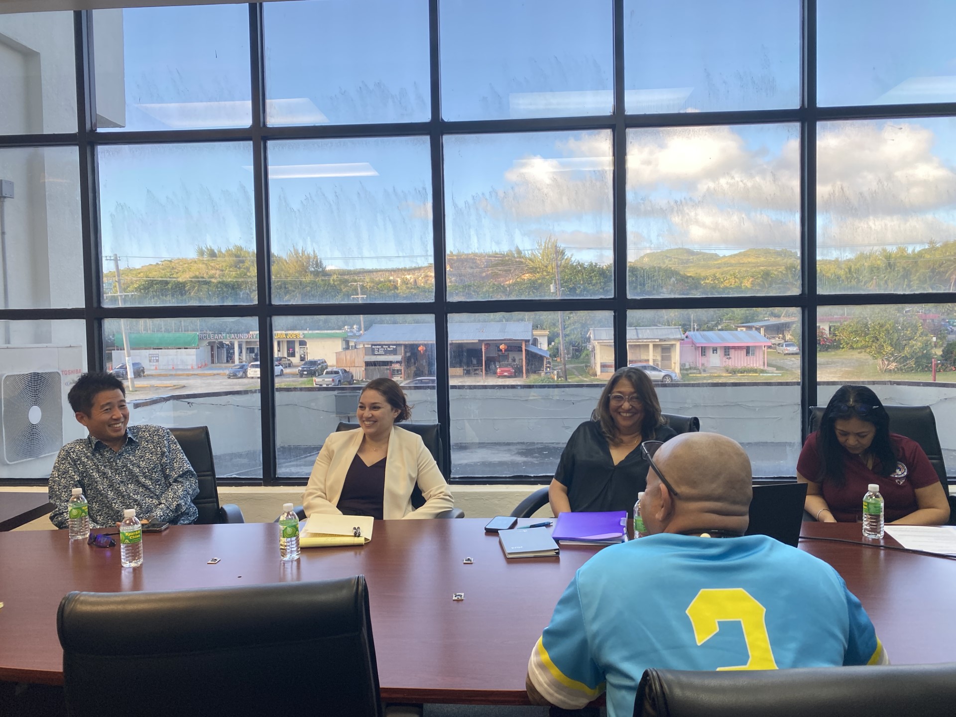 E-Land CEO Brian Shin, first left, and E-Land vice president Gloria Cavanagh, third from left, share a light moment during the Department of Public Lands’ public hearing at its Dandan office on Monday.
