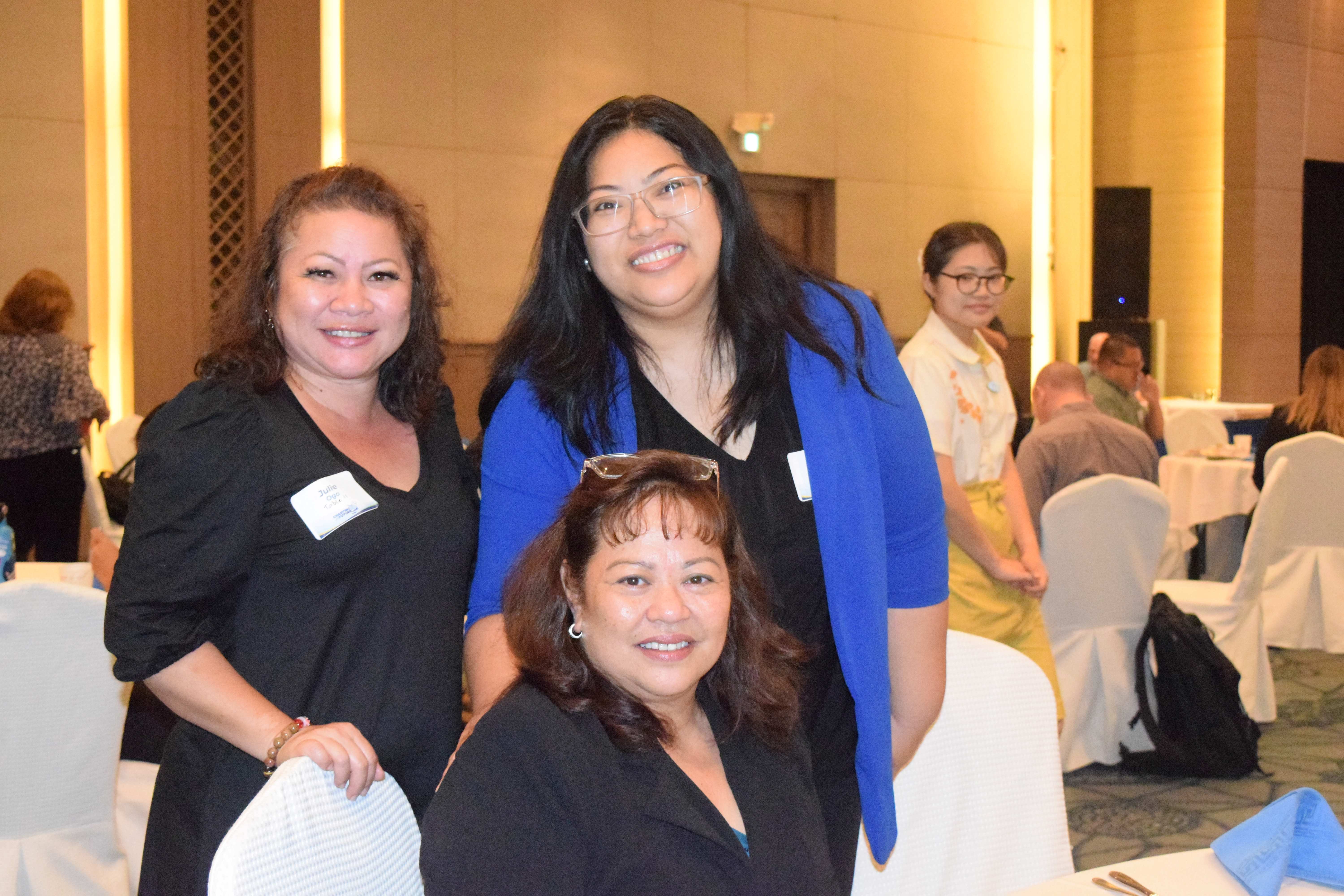 Rep. Julie Marie Ogo, Rota Mayor Aubry Hocog, and Sen. Celina Babauta pose for a photo during a break from the summit.