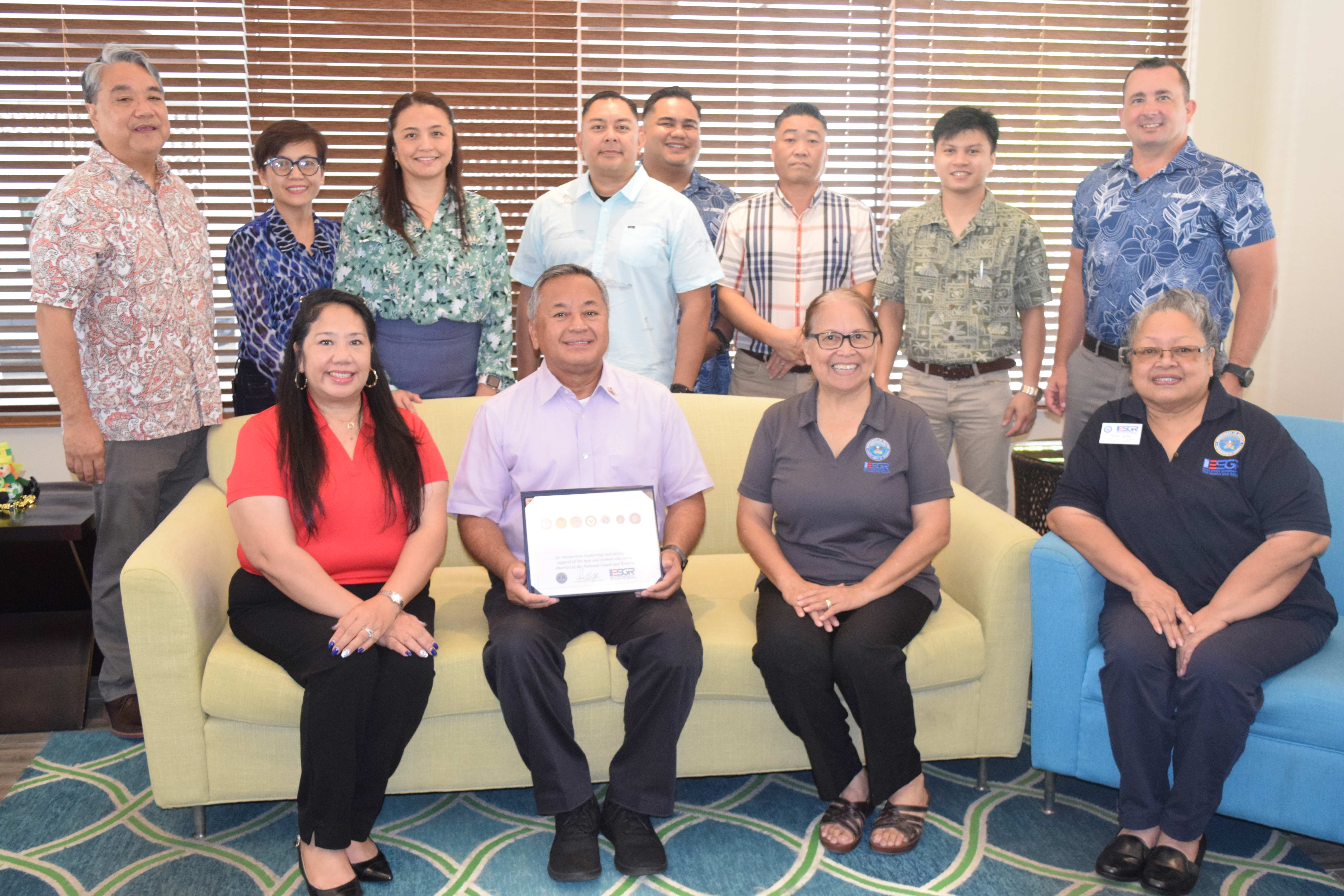Civilian Aide to the U.S. Secretary of Army and Triple J Enterprises Vice President for Finance and Administration Mike Sablan, center seated, holds the Seven Seals Award as he poses for a photo with Employer Support for the Guard and Reserve Guam-CNMI Area Chair Rita A. Sablan, Ed.D., second right, ESGR State Ombudsman Joann T. Aquino, left, Employer Outreach Coordinator Rose Igitol, right, and Triple J Enterprise officials in the Surfrider Resort Hotel lobby on Thursday.