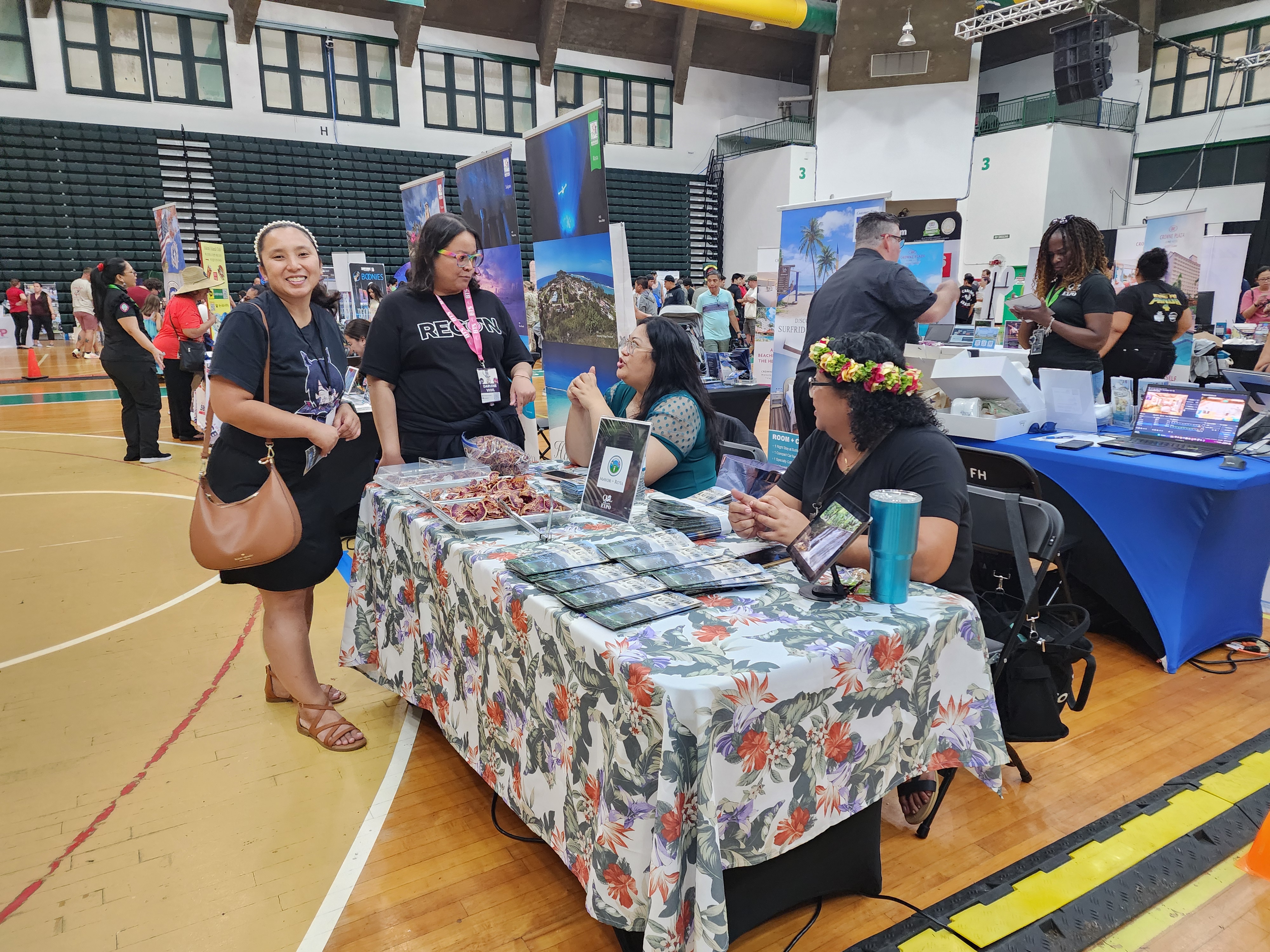 Rota Mayor Aubry Hocog, second right, shares information about the island of Rota in the Marianas at the Quality of Life EXPO 2024 on Feb. 24, 2024, at the University of Guam.  The travel show was organized by Joint Region Marianas to showcase regional resources and services to military service members and their families.
