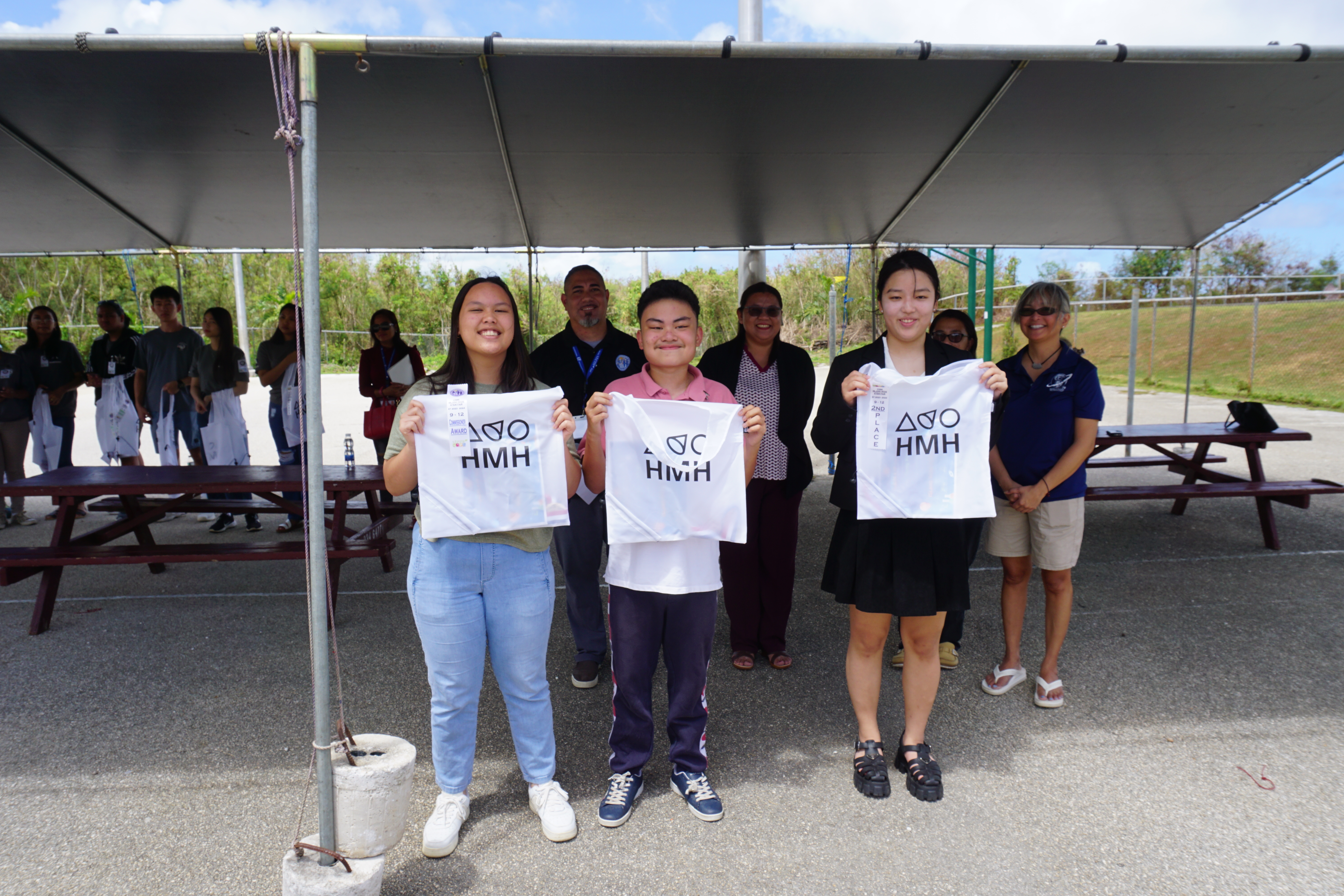 From left, Heleyna Dela Santa and Gavril Myles Santiago stand next to Ja Young Kim.
